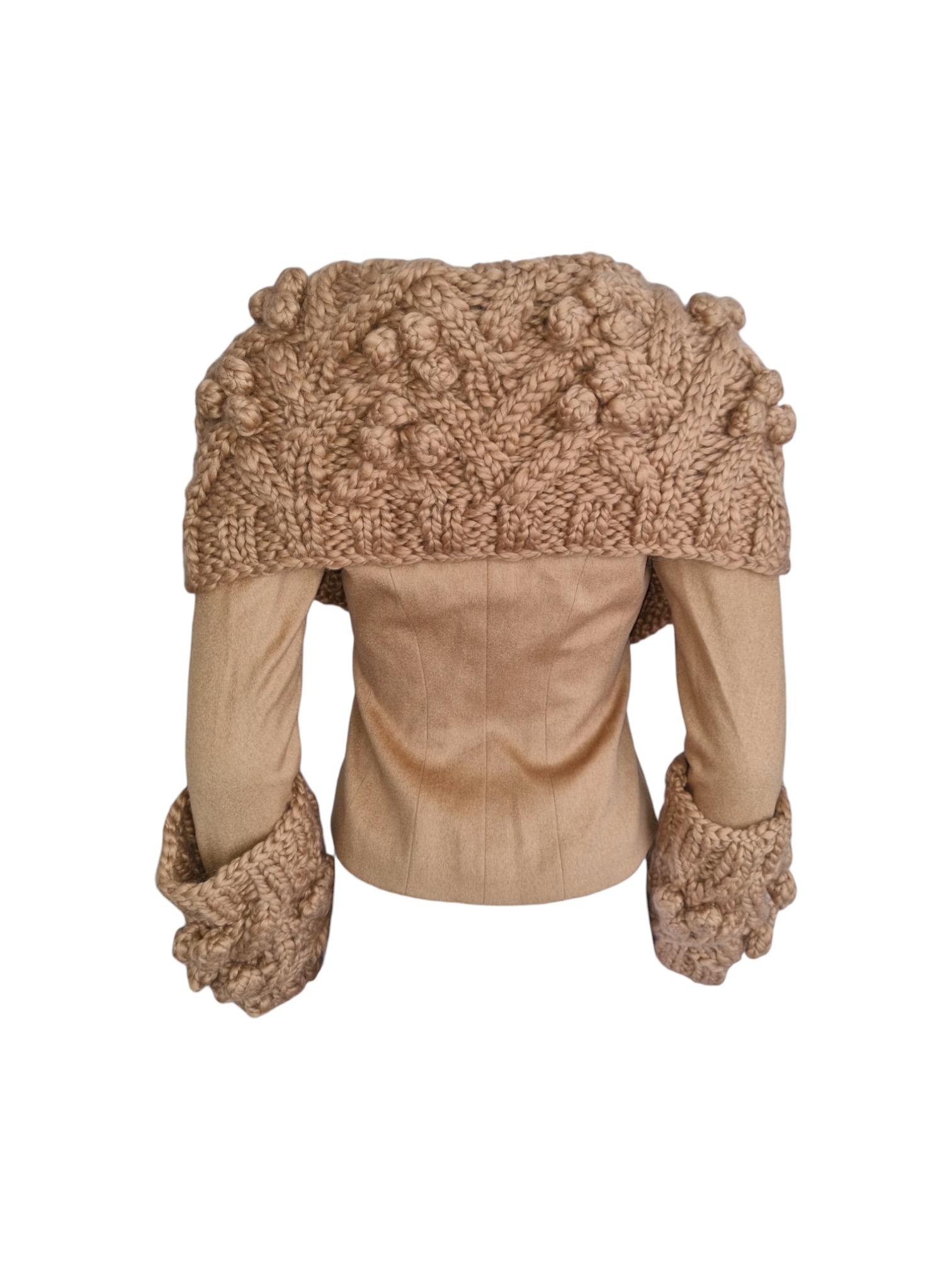 MyRunwayArchive presents this vintage blazer features an oversized shawl collar and cuffs in chunky-knit with pom-poms. A camel wool stands out for its unique texture, exceptional insulation, lightweight feel, and timeless elegance. It offers warmth