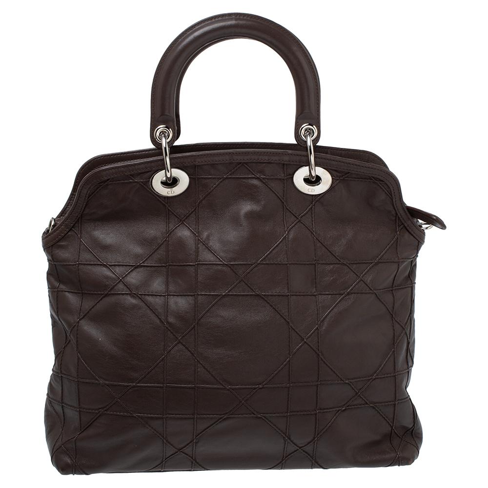 This chic and feminine Granville tote is from Dior. The bag is crafted from Cannage leather. Brown in color, the tote is easy to carry around. It features two top handles, a shoulder strap, protective metal feet, and a leather-fabric lined interior