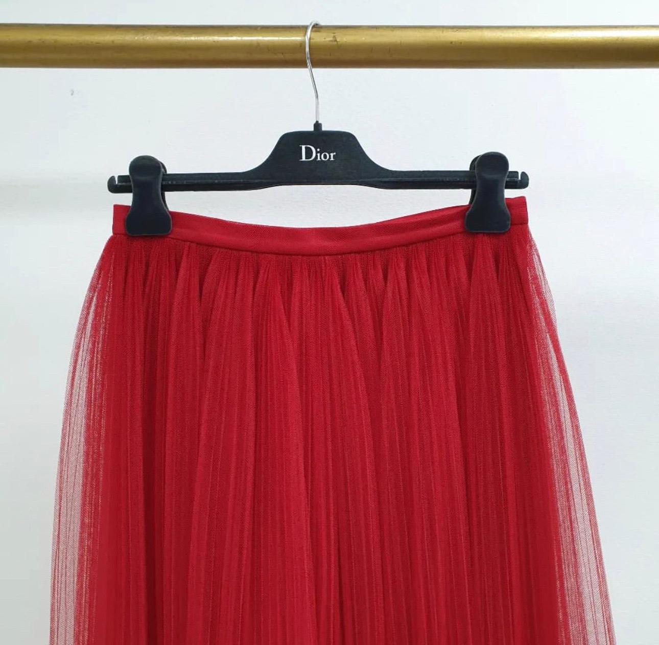 Take a more trendy approach towards fashion with this attractive skirt from Christian Dior!
 This red midi skirt is made of quality fabrics and features a gathered silhouette. 
Pair it with a simple top and ballet flats for a fashionable day out.