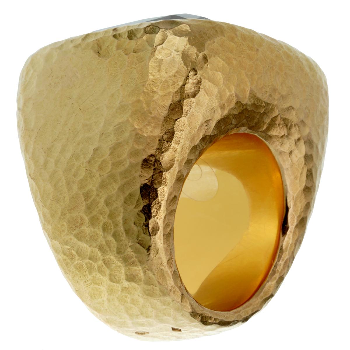 A showstopping Christian Dior cocktail ring for sale showcasing a massive 25ct appx Citrine in a hammered 18k yellow gold mounting. The ring measures a size 6 1/4