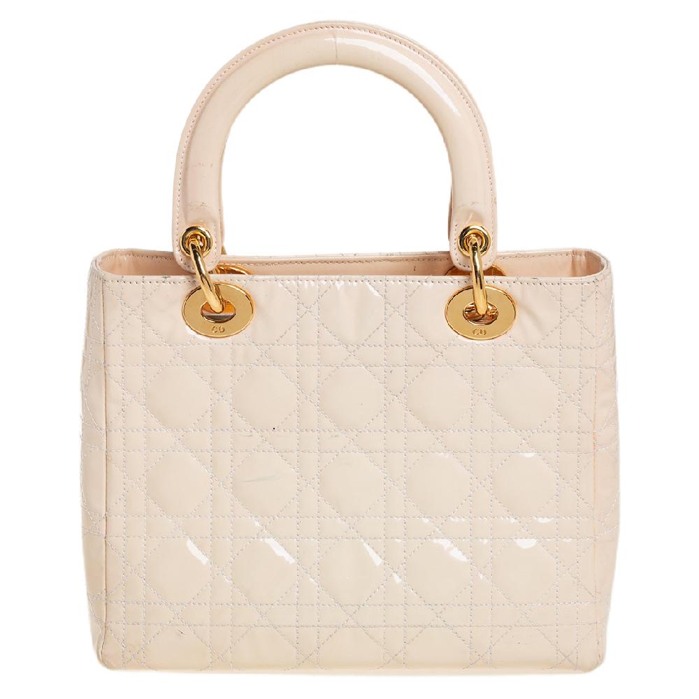 The Lady Dior tote is a Dior creation that has gained recognition worldwide and is today a coveted bag that every fashionista craves to possess. This cream tote has been crafted from patent leather and it carries the signature Cannage quilt. It is