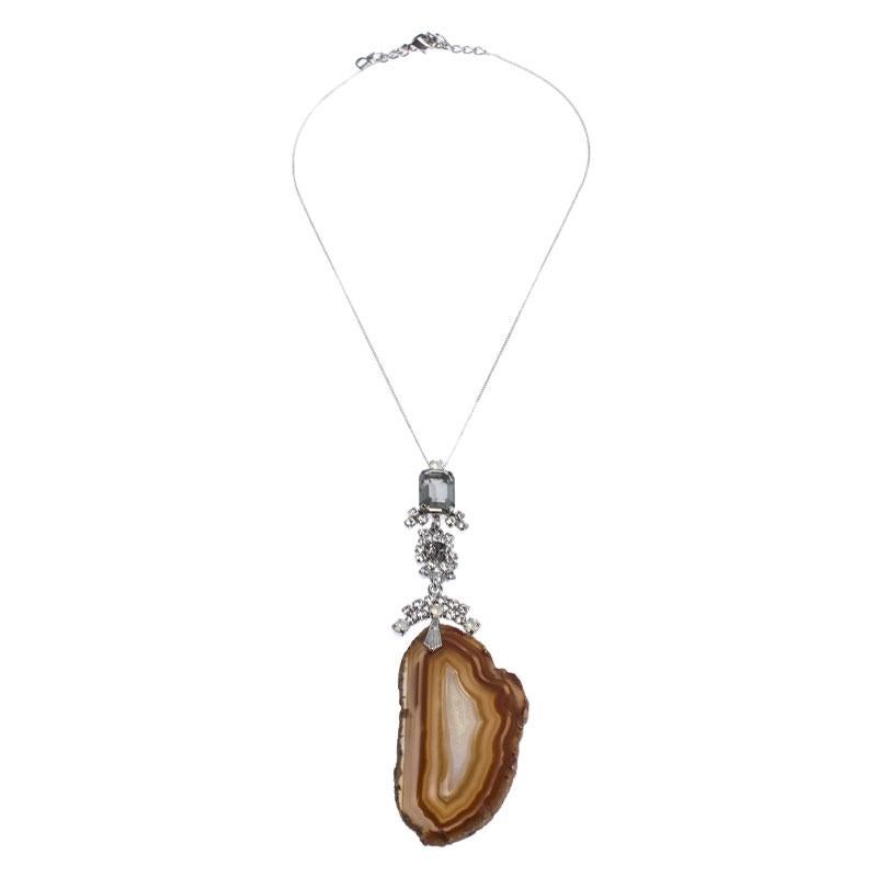 This lovely necklace by Dior will make a timeless addition to your collection. Crafted from silver-tone metal, this gorgeous creation has a chain that holds crystal-set motifs and an agate log charm. It is finished with a lobster clasp.

Includes: