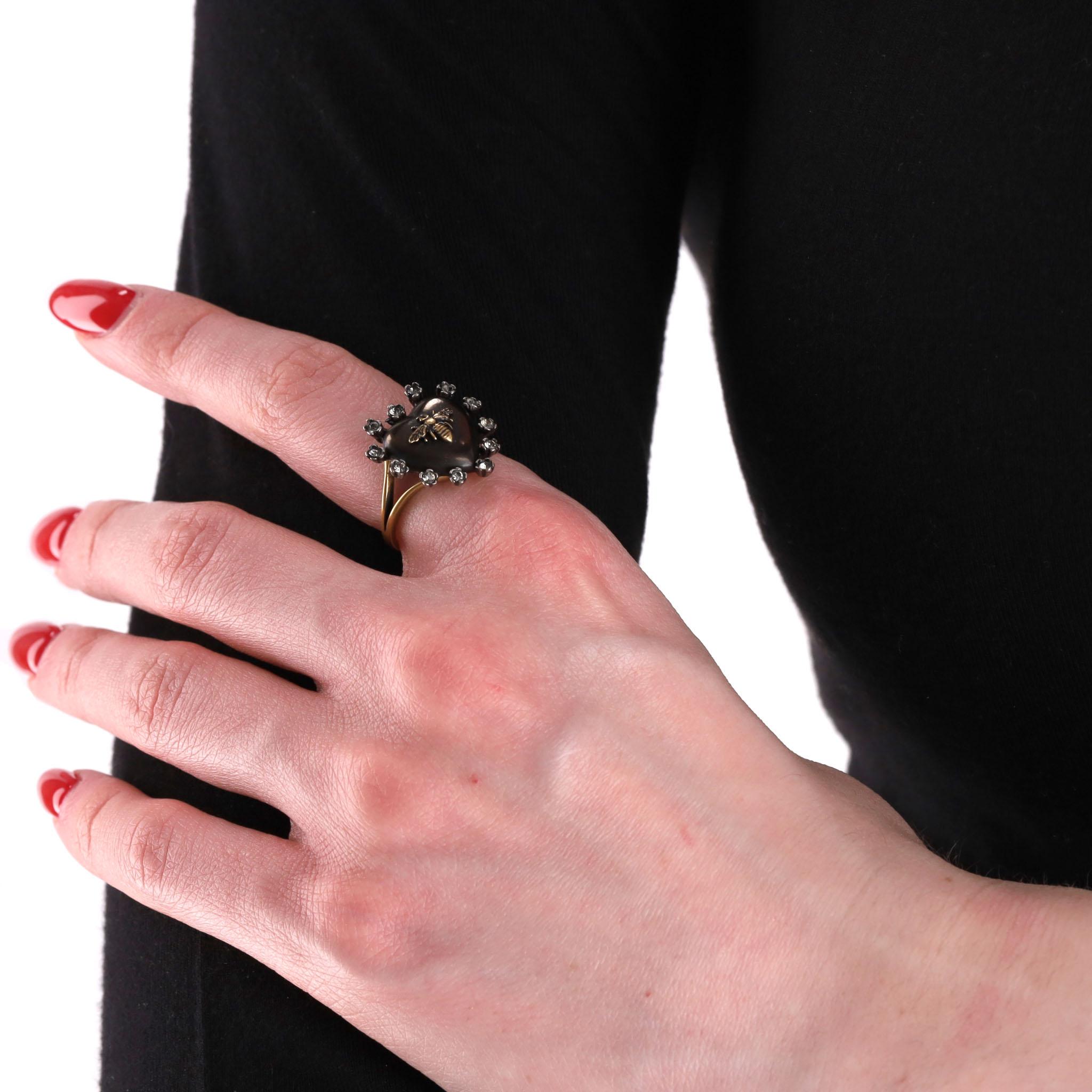 Statement Ring - Dior Crystal Heart-Shaped Bee Ring

Aged gold metal ring with resin heart-shaped centre adorned with white crystals.

Dior's iconic 'Bee' symbol to the centre and 'Dior' signature to the inside.

Rrp Approx. £300

Size – One