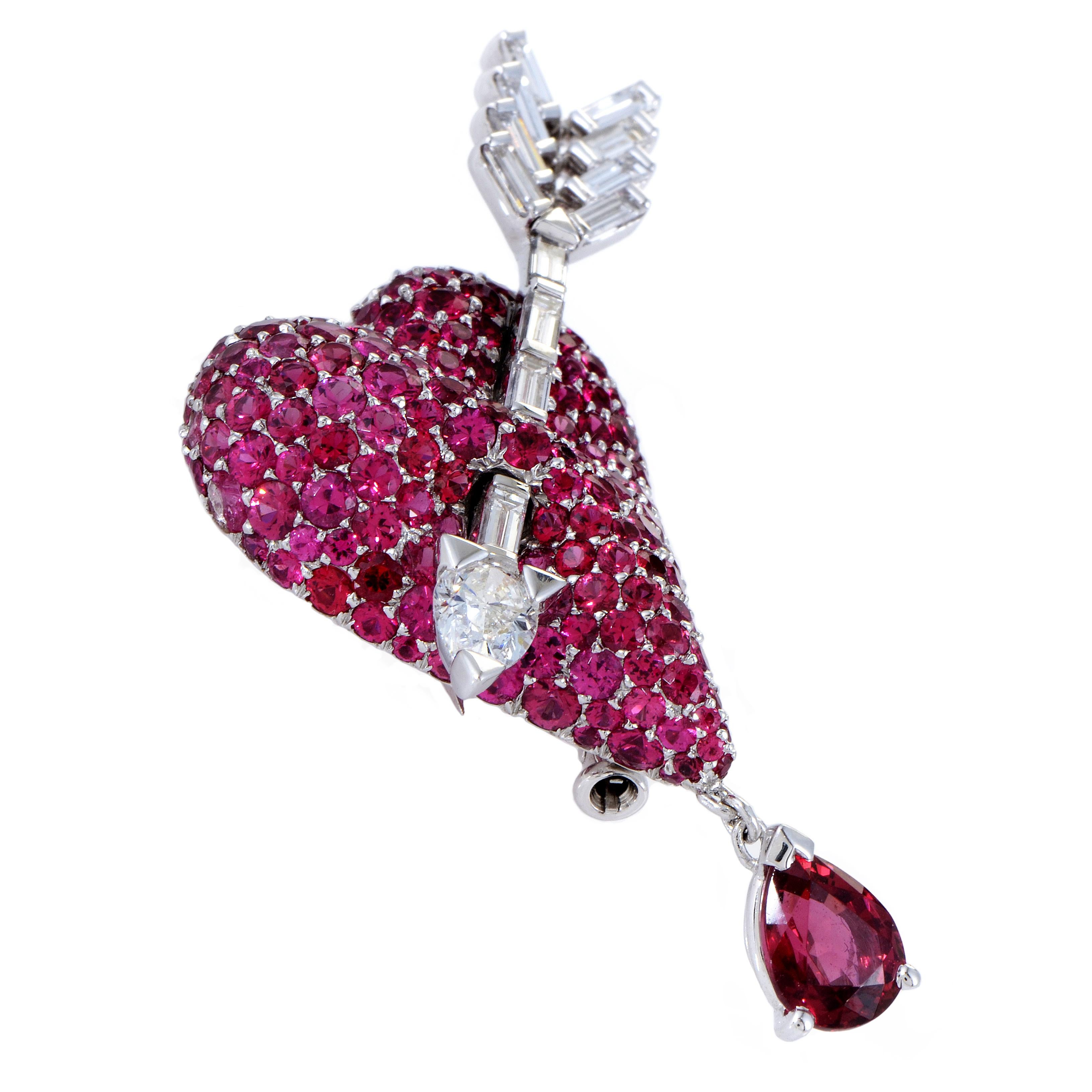 A lustrous diamond-set arrow pierces through a luscious heart paved with romantic and passionate rubies and red spinel in this exceptional brooch from Dior which is made of 18K white gold and boasts a total of 1.20 carats of glistening diamonds.
