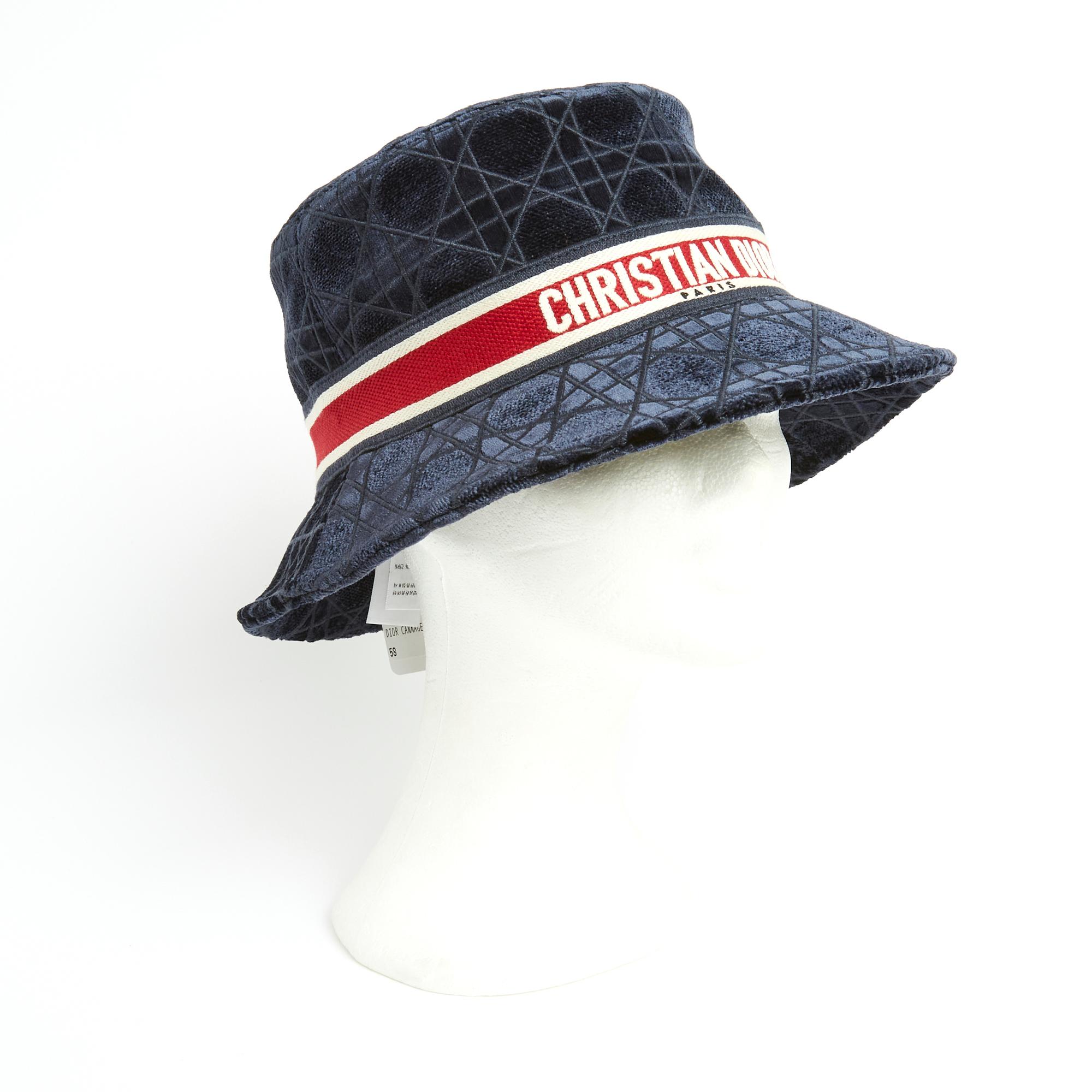 Christian Dior hat, D-Bobby model, in quilted navy blue velvet with small brim cannage motif, contrasting ribbon inscribed Christian Dior Paris, matching cotton lining. Size 58. The hat is probably from private sales, in perfect condition, with its