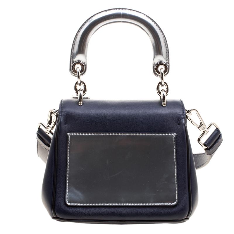 Wear it though the day and day time events and instantly transform it into your evening wear bag, this elegant and stylish versatile Be Dior bag from Dior is a must have piece. Crafted in dark blue leather, this bag features a silver tone chain and