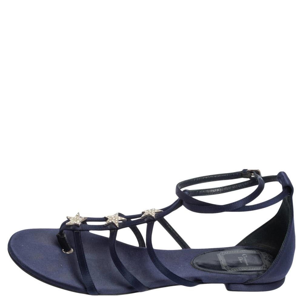 How pretty are these black flat sandals from the house of Dior! They are designed with satin uppers in a strappy design with star embellishments. They have silver-tone hardware and a dark blue shade. Team them with your casual dresses.