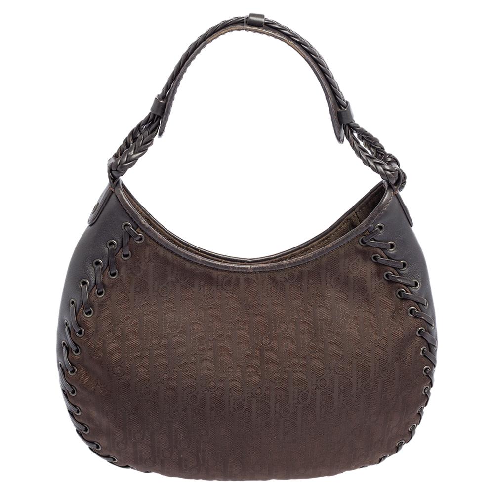 Crafted with Oblique nylon, trimmed with leather, and lined with the finest nylon you will find this bag an ideal companion for all your needs. You cannot go wrong with this one from Dior, designed in a shade of dark brown. It features whipstitch