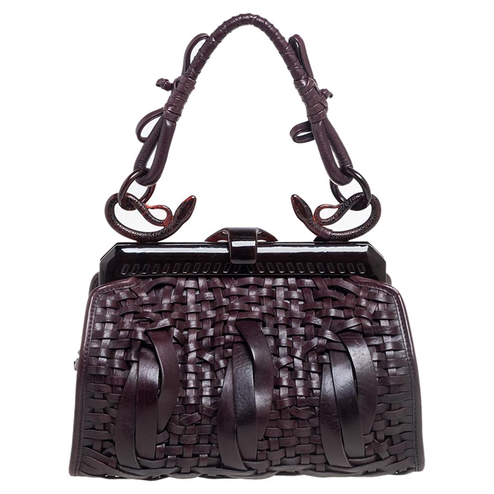 This limited-edition Dior bag comes with a sophisticated exterior crafted from quality woven leather and accented with exquisite stitch detailing. It comes in a lovely shade of dark brown and is designed with a framed top, a well-designed handle,