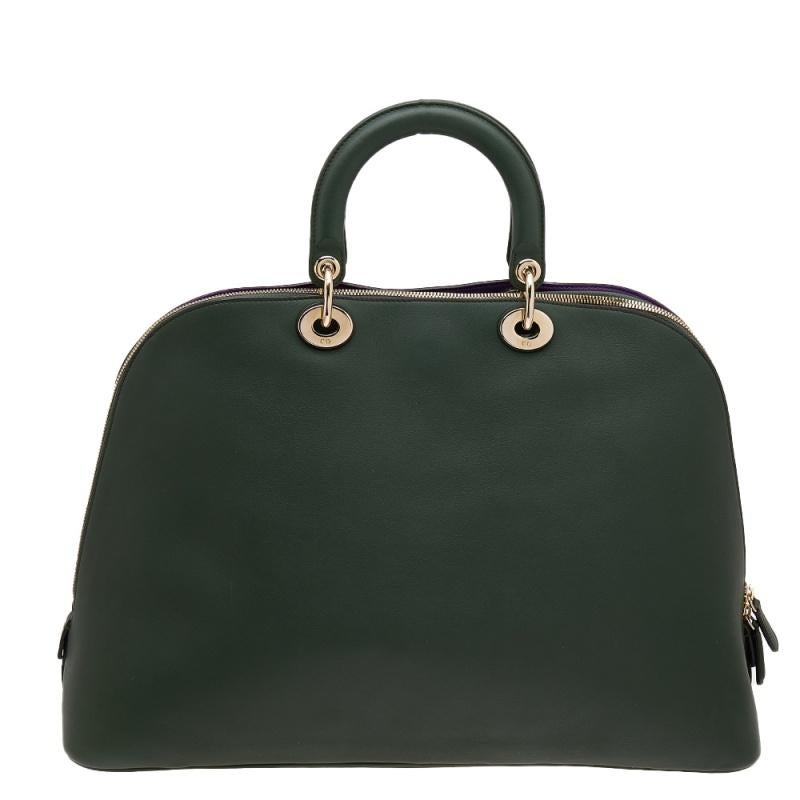 This Dior dome satchel is the flawless arm candy that anyone can wish for. Crafted from leather, it is the perfect travel piece. Its interior is lined with leather and is sized to fit your essentials easily. Stylish and functional is what you can