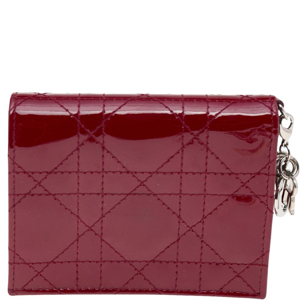 The Lady Dior collection from the House of Dior has gained a reputation for being one of the most iconic, admired collections of the brand. This mini Lady Dior wallet has been made using red Cannage patent leather on the exterior and is embellished