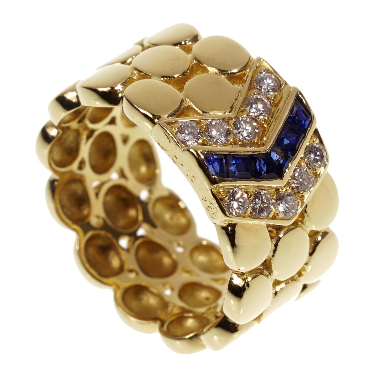 A chic Christian Dior ring showcasing a chevron motif adorned with sapphire and round brilliant cut diamonds in 18k yellow gold.

Size 6 1/2
