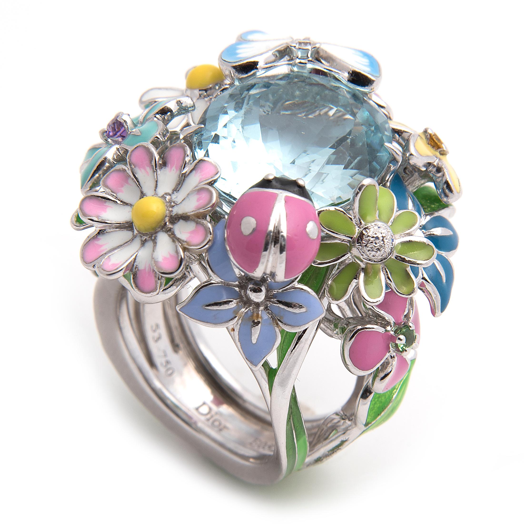 Flower ring from Dior's 'Diorette' collection, large model. 
White gold set with a large aquamarine and decorated with lacquer flowers, a butterfly and a ladybird, the flowers set with Amethyst, Pink sapphire, Yellow sapphire and Tsavorite garnet,