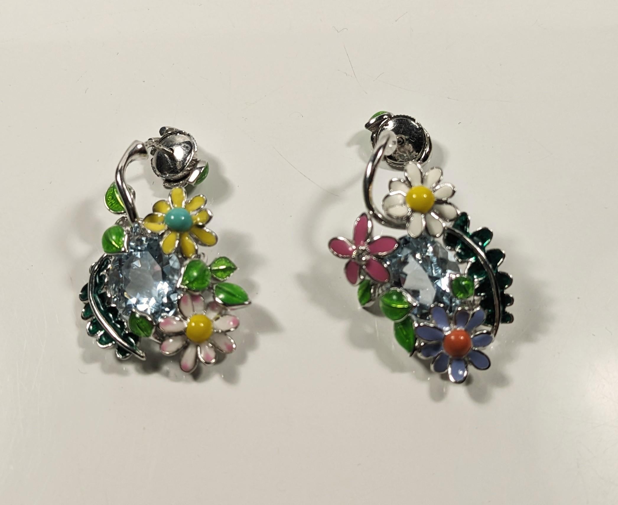 Dior Diorette Earrings 18 kt white gold, diamonds and enamel
Diorette, a bold collection, an ode to the flowers and plant fantasies of Christian Dior's garden in Milly-la-Forêt.

Openwork design with enameled decoration, aquamarine and a
