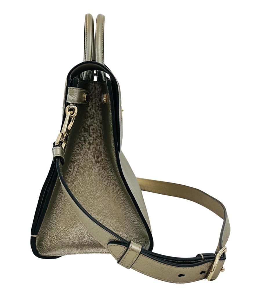 Dior Diorever Metallic Leather Flap Bag
Silver gold trapeze shaped handbag crafted in grained calfskin leather.
Featuring rolled top handle and detachable shoulder strap.
Detailed with 'Dior' engraved press lock closure leading to leather interior