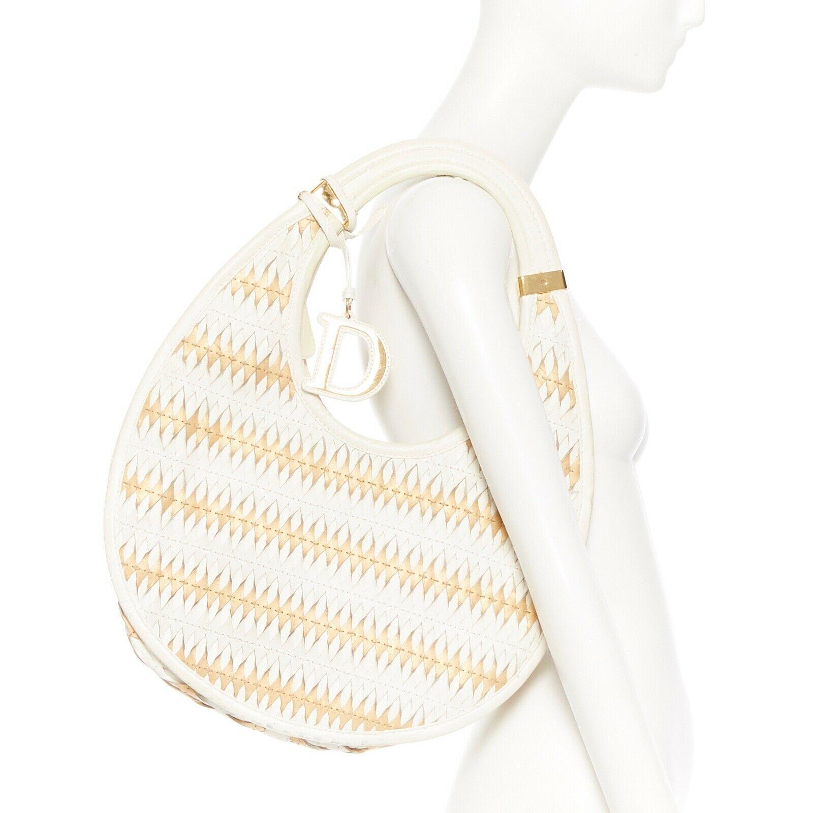 DIOR diorita white gold crescent wove 3D laser cut twist filter leather hobo bag
DIOR BY JOHN GALLIANO
Dior Diorita style. 
Crescent shaped hobo bag. 
White and gold leather upper. 
Laser-cut, twisted and weaved designs. 
Unique 3D effect. 
Gold