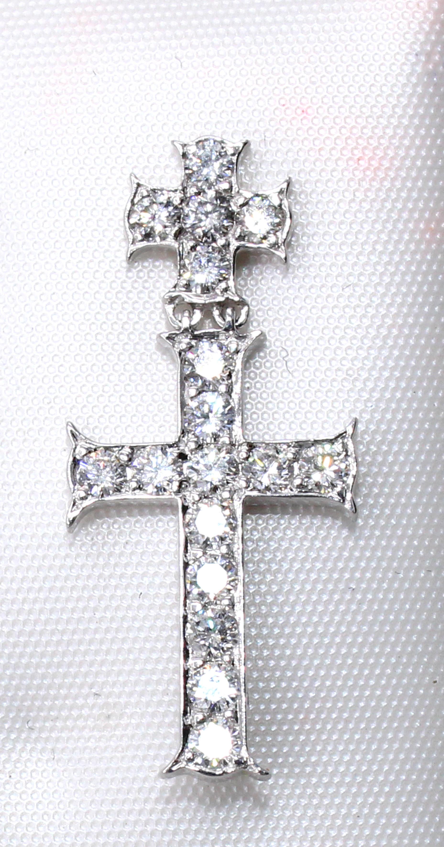 Beautifully designed and masterfully handcrafted in 18 karat white gold, this flexible double-cross lapel pin/pendant makes a chic statement on any jacket or blouse. Set with 17 perfectly matched white bright and sparkly round brilliant cut