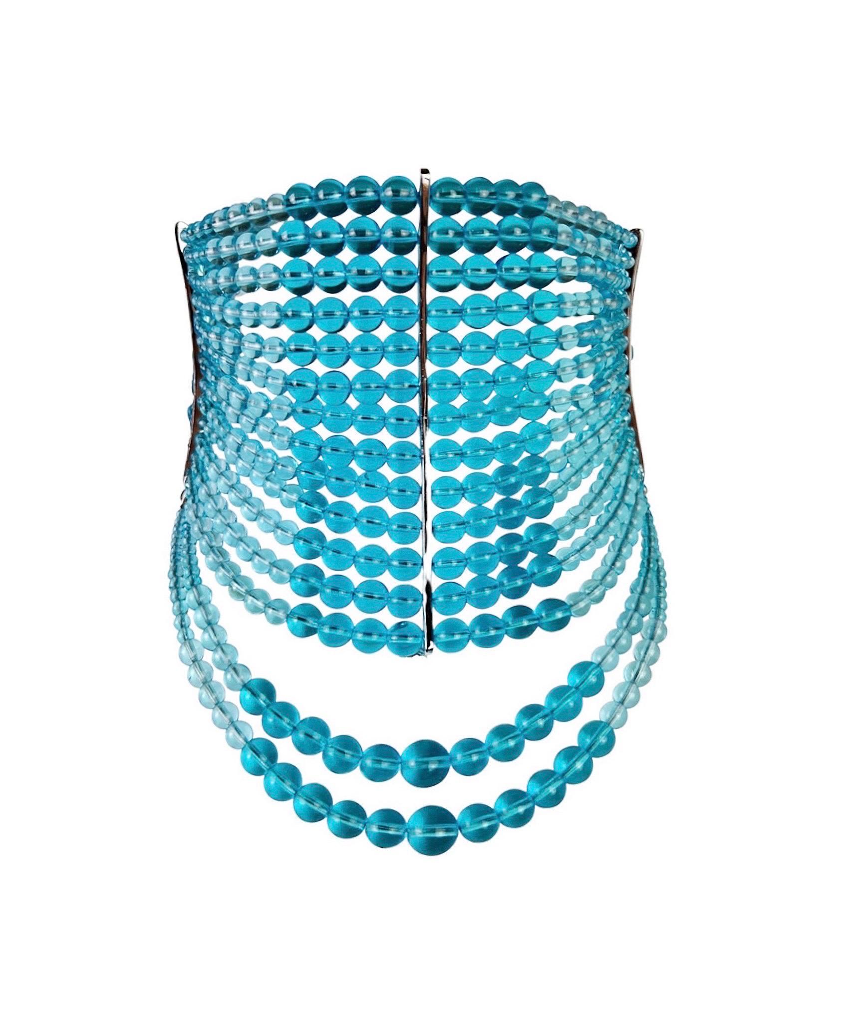 A truly iconic Dior Masai necklace in a stunning clear turquoise blue glass and silver-toned hardware. A similar style was seen recently on Rihanna. 

Length - 32-38 cm (12,5-15 in)
Height (central metal plank)  - 10 cm (4 in)
Excellent vintage