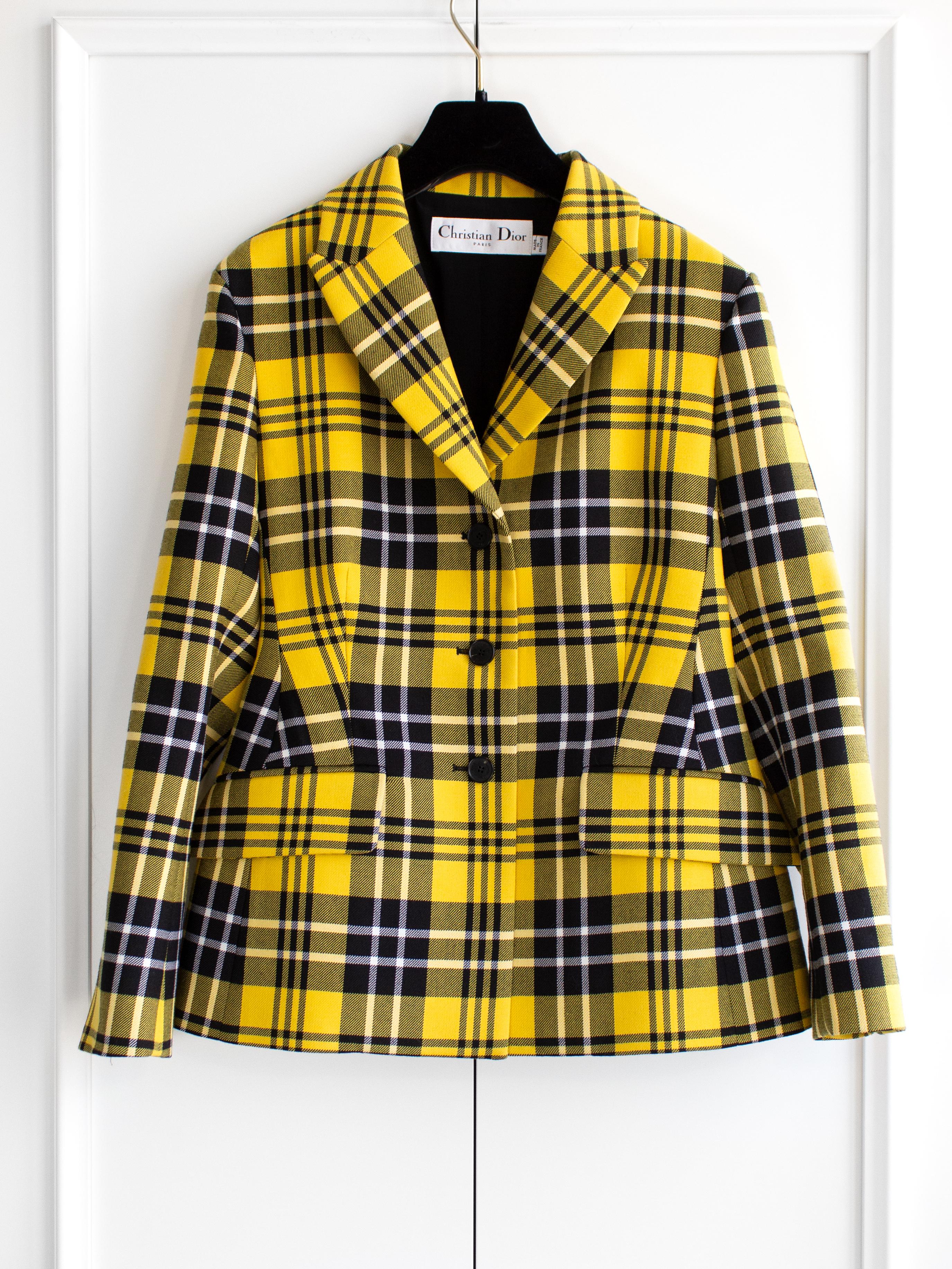 Check out the hottest item from Dior's Fall/Winter 2022 collection – the yellow and black plaid bar blazer. It's got that school uniform vibe, with a nod to Cher Horowitz's iconic 'Clueless' look. This blazer has been spotted on celebs like Olivia