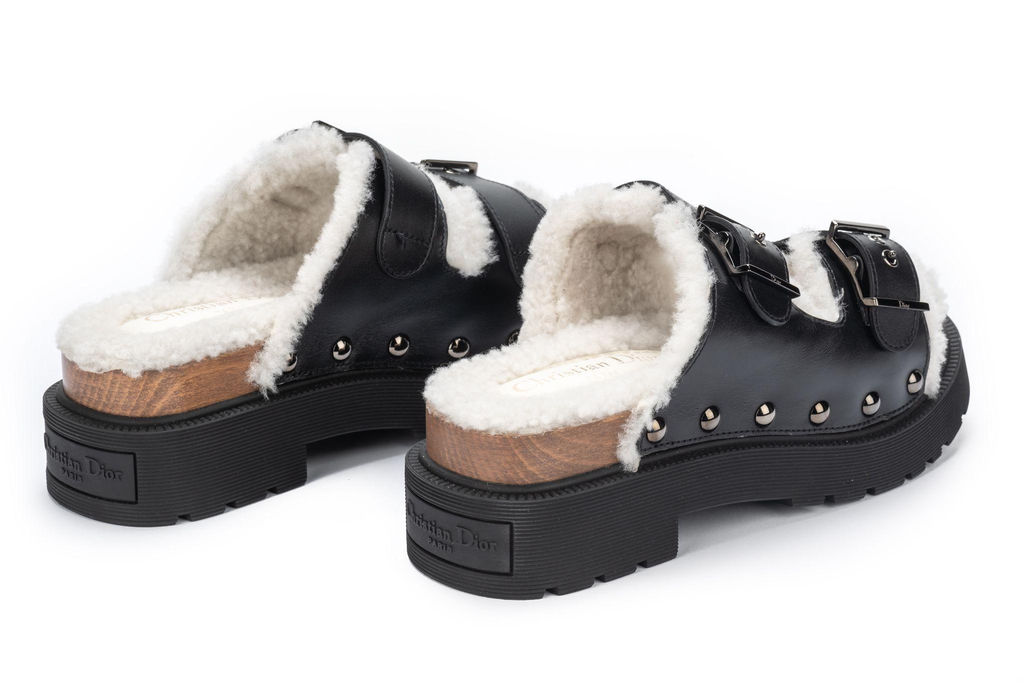 Christian Dior Faux Fur Sandals with a wooden block sole. The top is made of black leather. They're new and come with the original box. US Size 6.5.