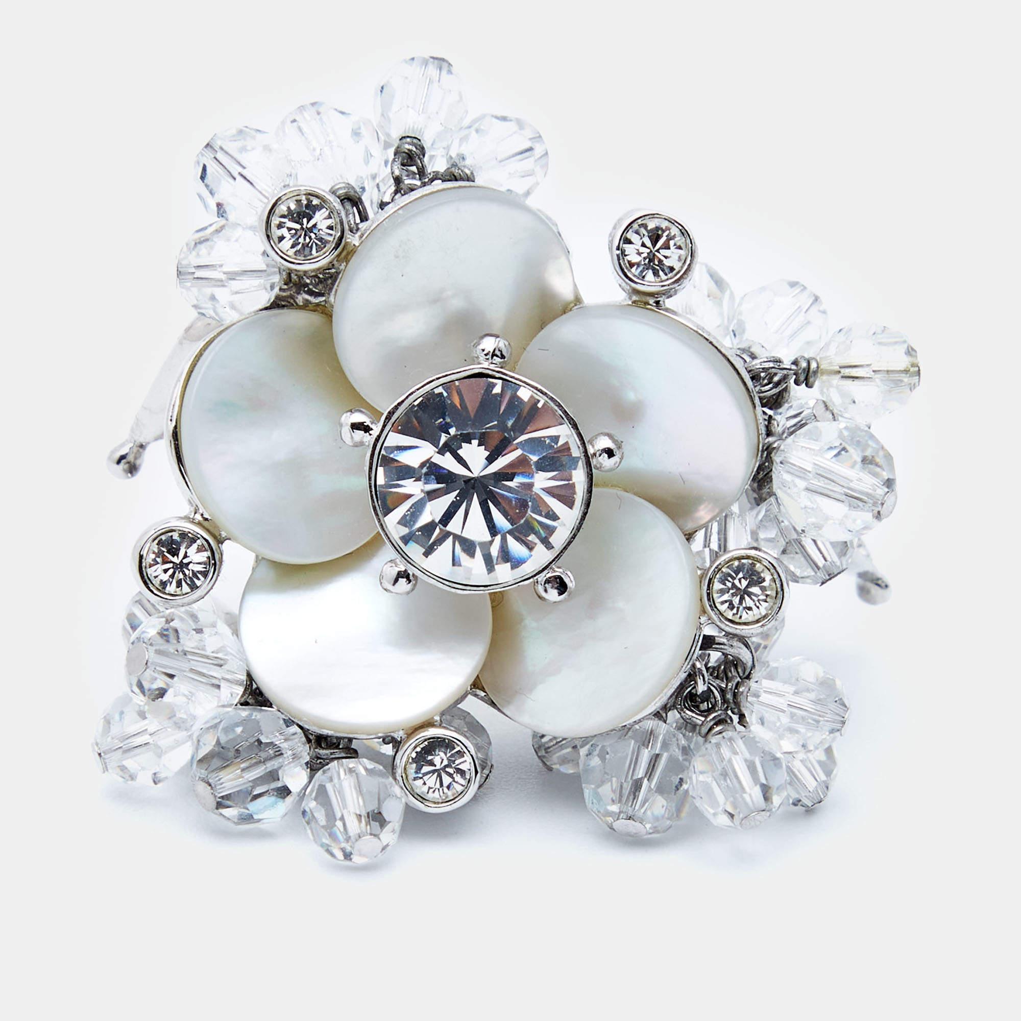Well-crafted accessories are a sign of creativity and style. From Dior, this ring is designed to be flaunted. Crafted from silver-tone metal, this piece has an embellished, cutout band and a cluster of faux pearls and crystals surrounding a notable
