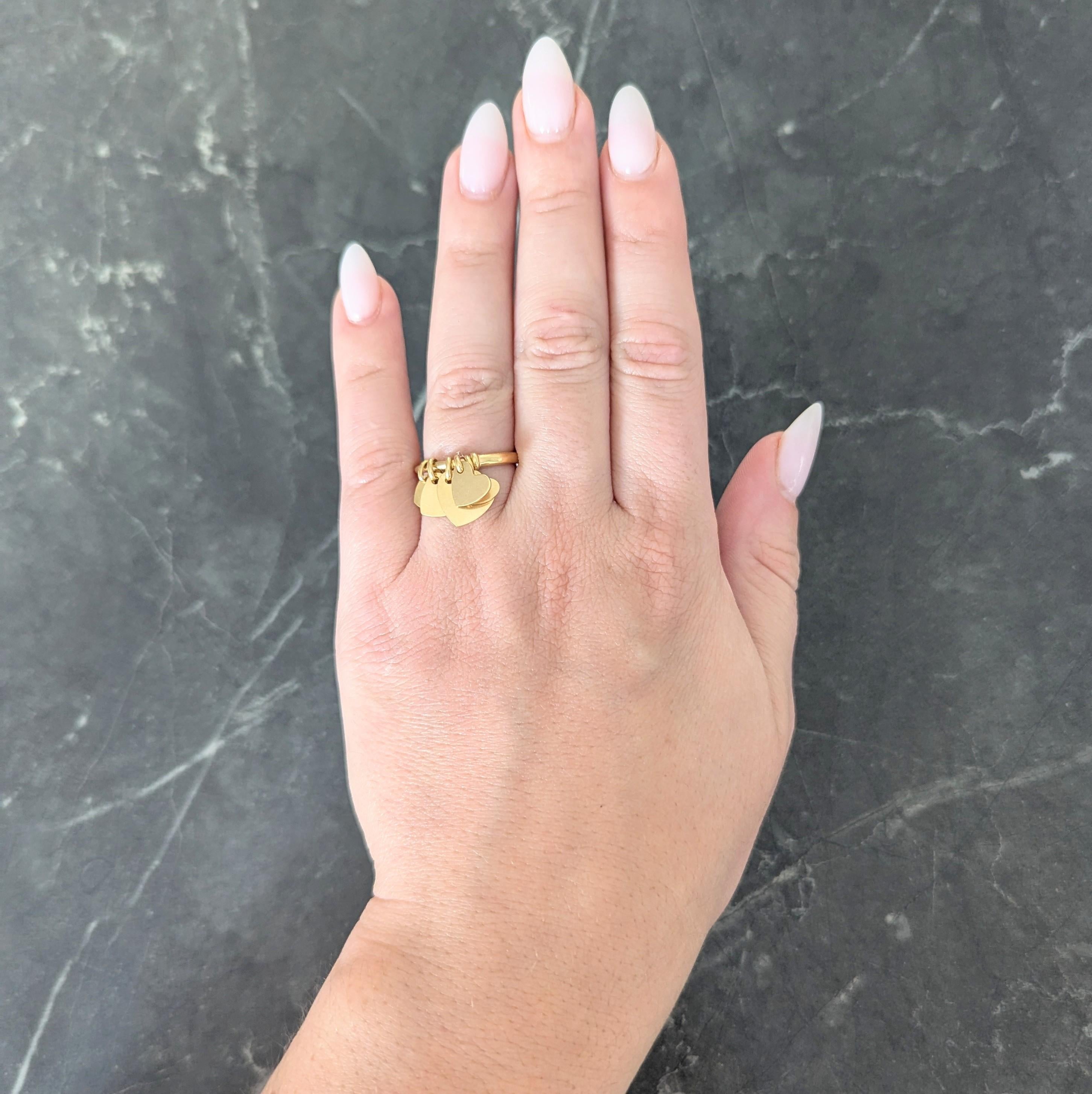 Designed as a rounded band centering a charm station
Comprised of graduated heart shaped charms
Articulating via jump rings
Stamped with French hallmarks for 18 karat gold
Numbered and fully signed for Dior
With maker's mark
Circa: 2000s; via the
