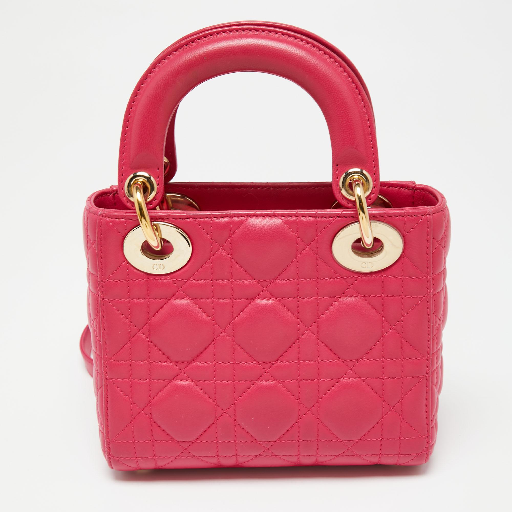 The Lady Dior's timeless status and never-aging beauty have made it an iconic accessory and a great fashion investment. We have here this mini Lady Dior tote, sewn using fuchsia leather and fitted with two top handles, a shoulder strap, and Dior