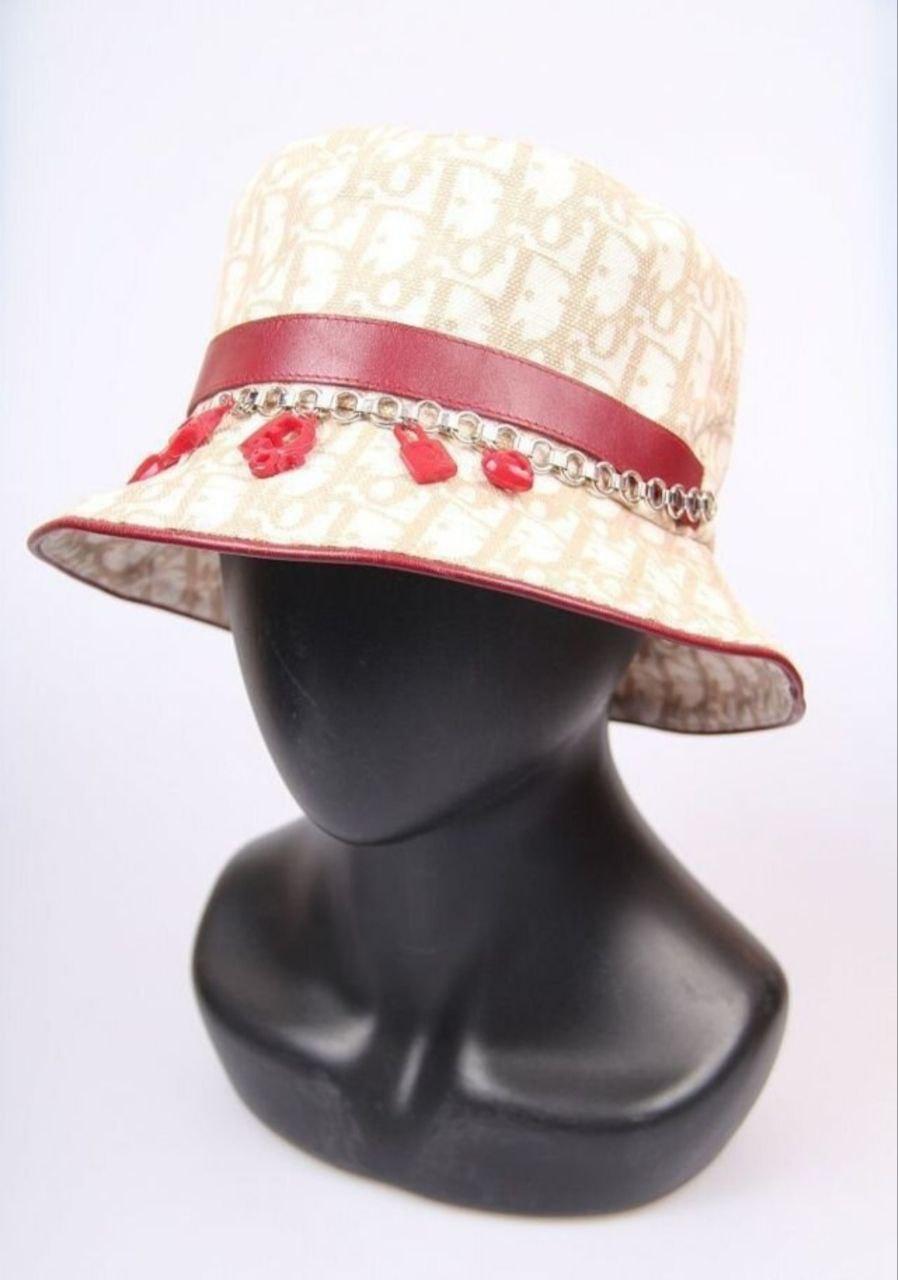 Dior Galliano Dior Trotter Charms Monogram Oblique Bucket Hat Diorissimo 57
Christian Dior bucket hat in the designer's most recognizable print in beige canvas with Dior logo with burgundy leather insert and 5 fun red resin charms.
Christian Dior