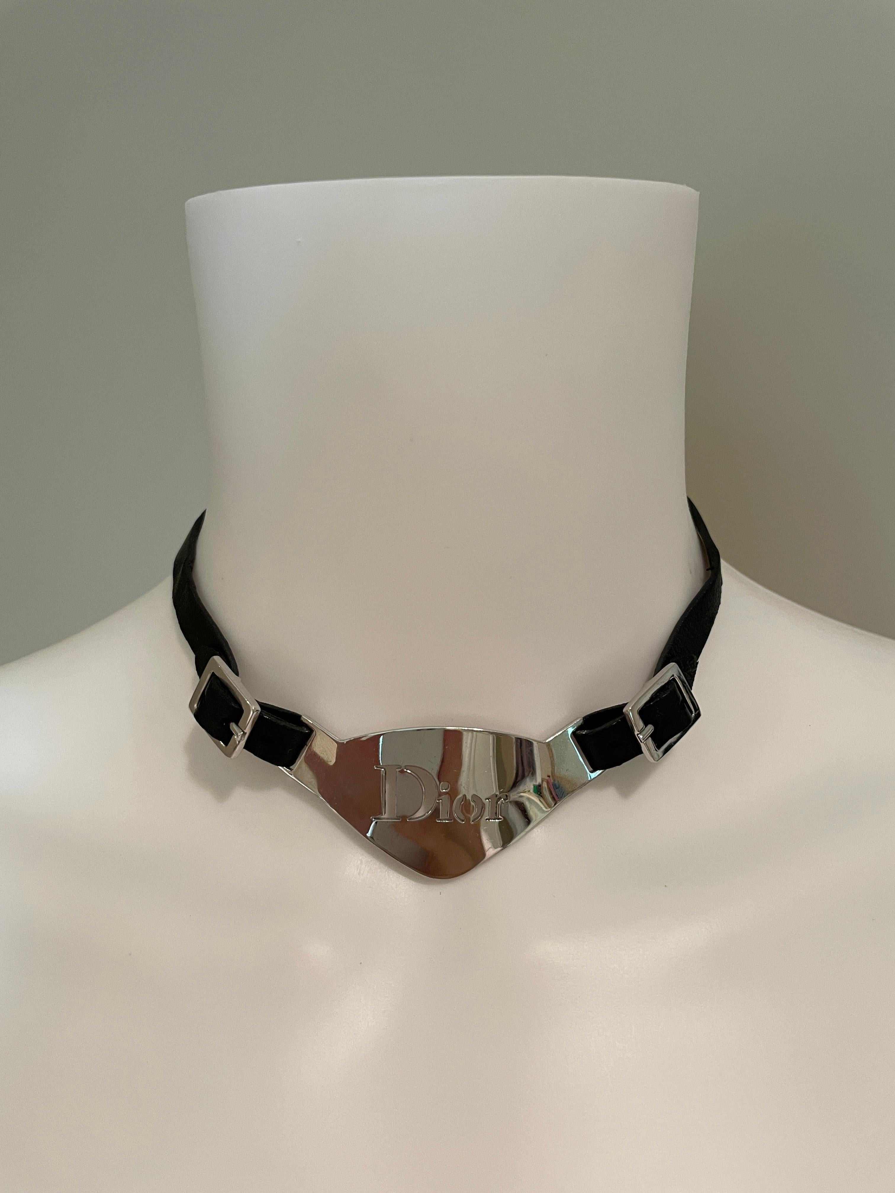 John Galliano for Christian Dior silver metal logo plate necklace. The black leather part of this choker is adjustable via the front 2 buckles, as well as extra links in the back. Good condition, consistent with wear. Scratches in the metal and the