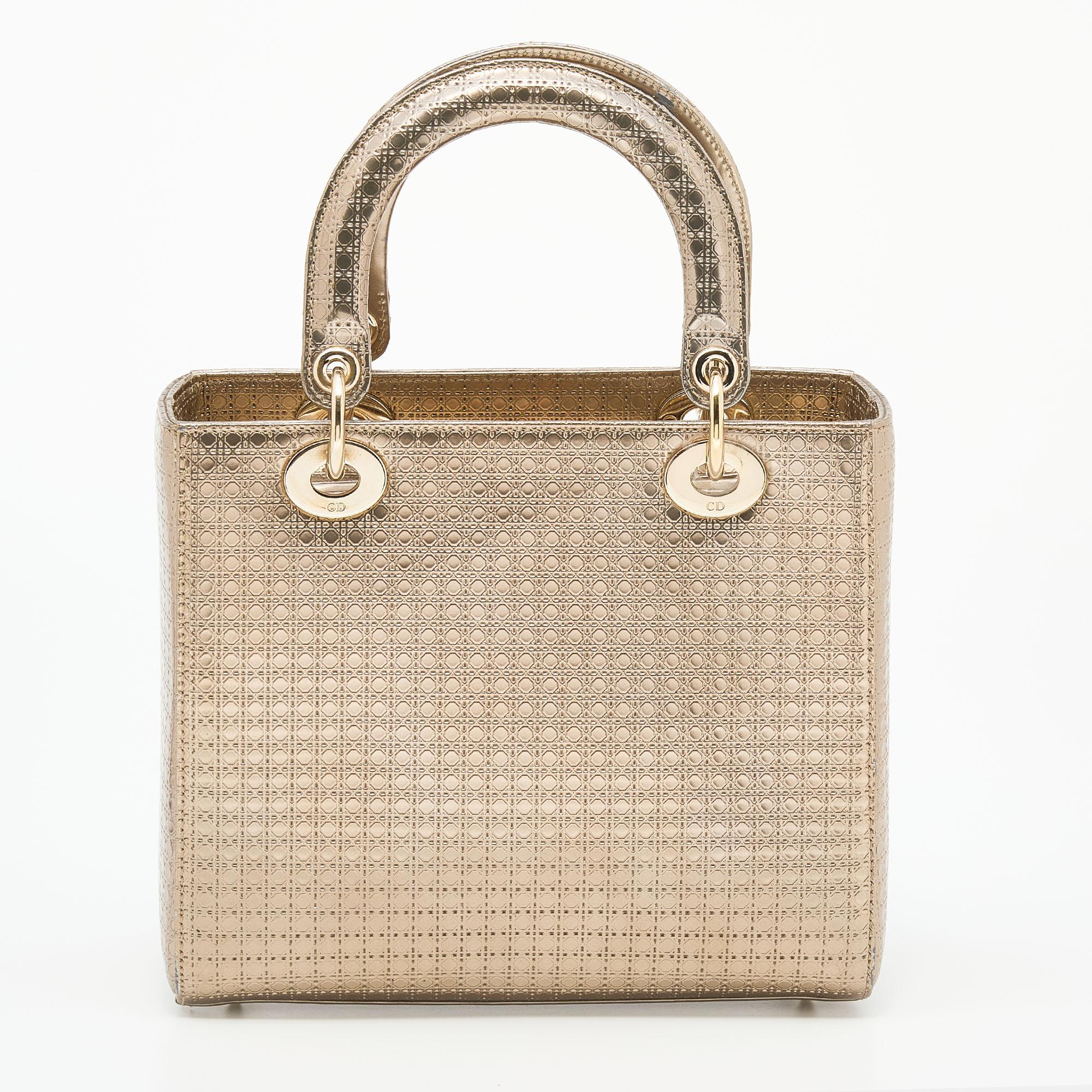 An investment-worthy handbag, the Lady Dior tote is an iconic design coveted by fashionistas around the world. This gold-hued version has been crafted from leather and features the label's signature Microcannage pattern throughout. It is held by