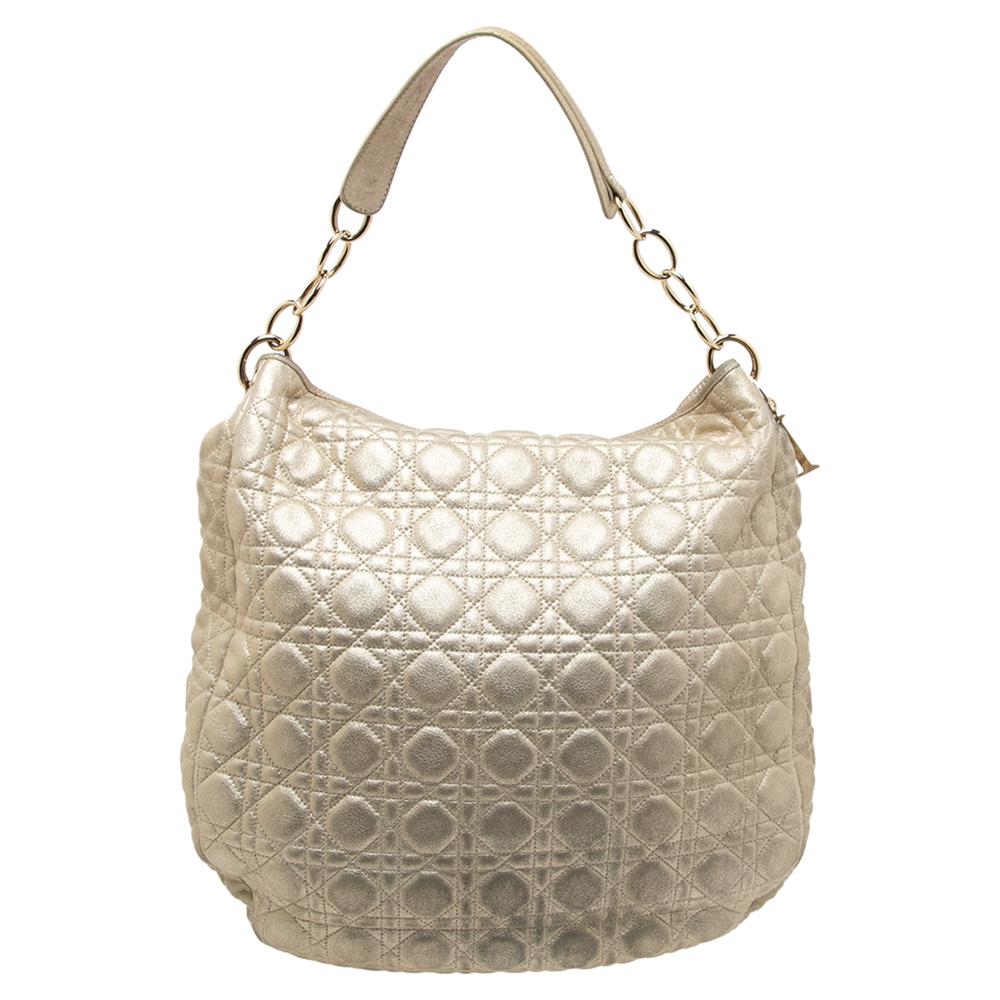 Complete your look of the day with this Dior hobo. Crafted from leather, it is accented with Cannage quilting and gold-tone hardware. The hobo features a single shoulder handle and a suede-lined interior.

Includes: Original Dustbag, Authenticity
