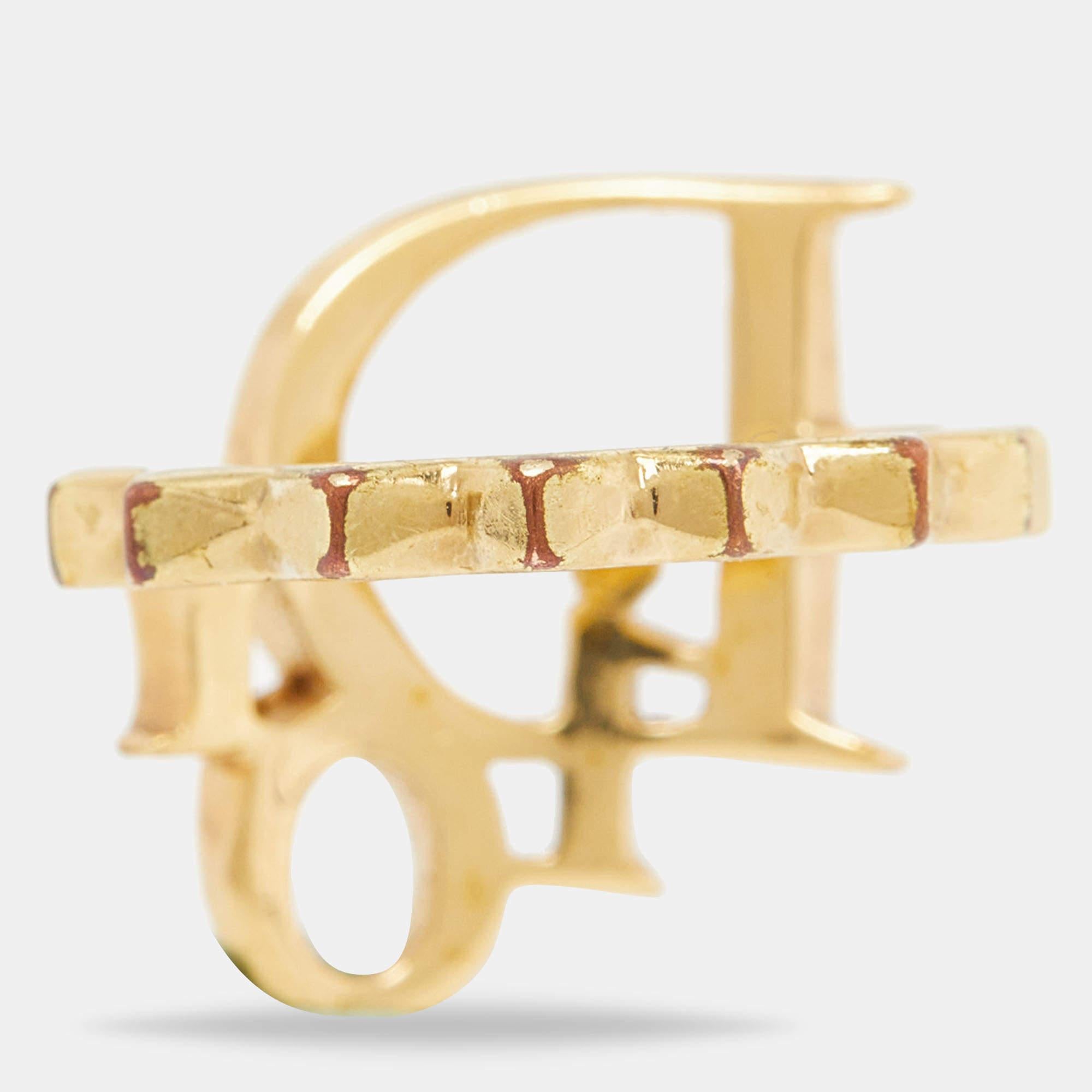 Simple yet sophisticated, this ring comes from the house of Dior. It has been crafted from gold-tone metal and designed with studs and the signature DIOR letters, all beautifully adorned with crystals. The piece is complete with the brand name on