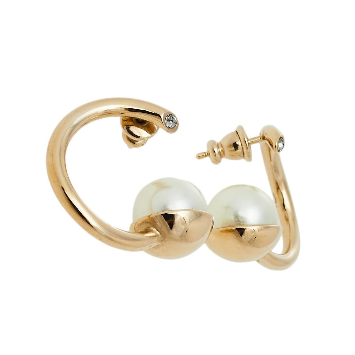 Enough to make a statement on its own, this pair of earrings from Dior has been made to delight all fashion lovers. They are made from gold-tone metal in a hoop style and detailed with faux pearls and petite crystals.

Includes: Original Box,
