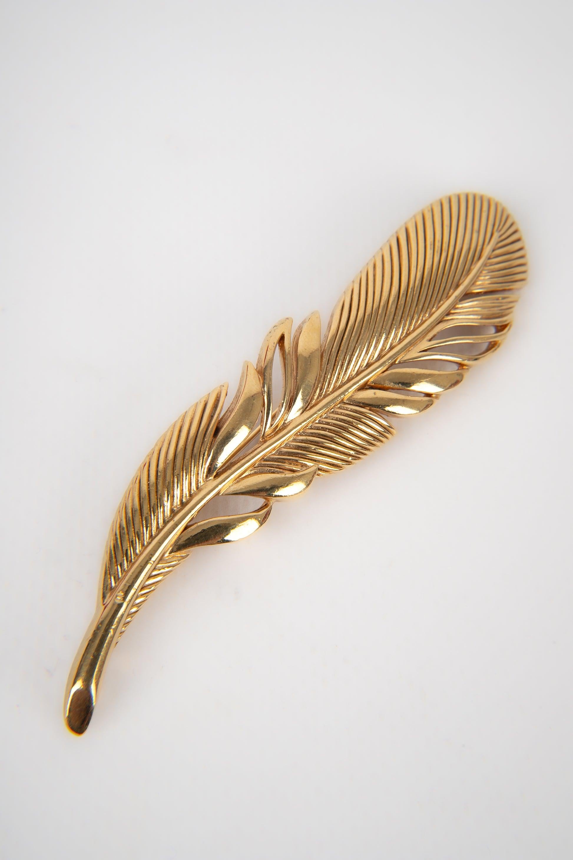 Dior - (Made in France) Golden metal brooch representing a feather.
 
 Additional information: 
 Condition: Very good condition
 Dimensions: 9 cm x 2.5 cm
 
 Seller Reference: BR141