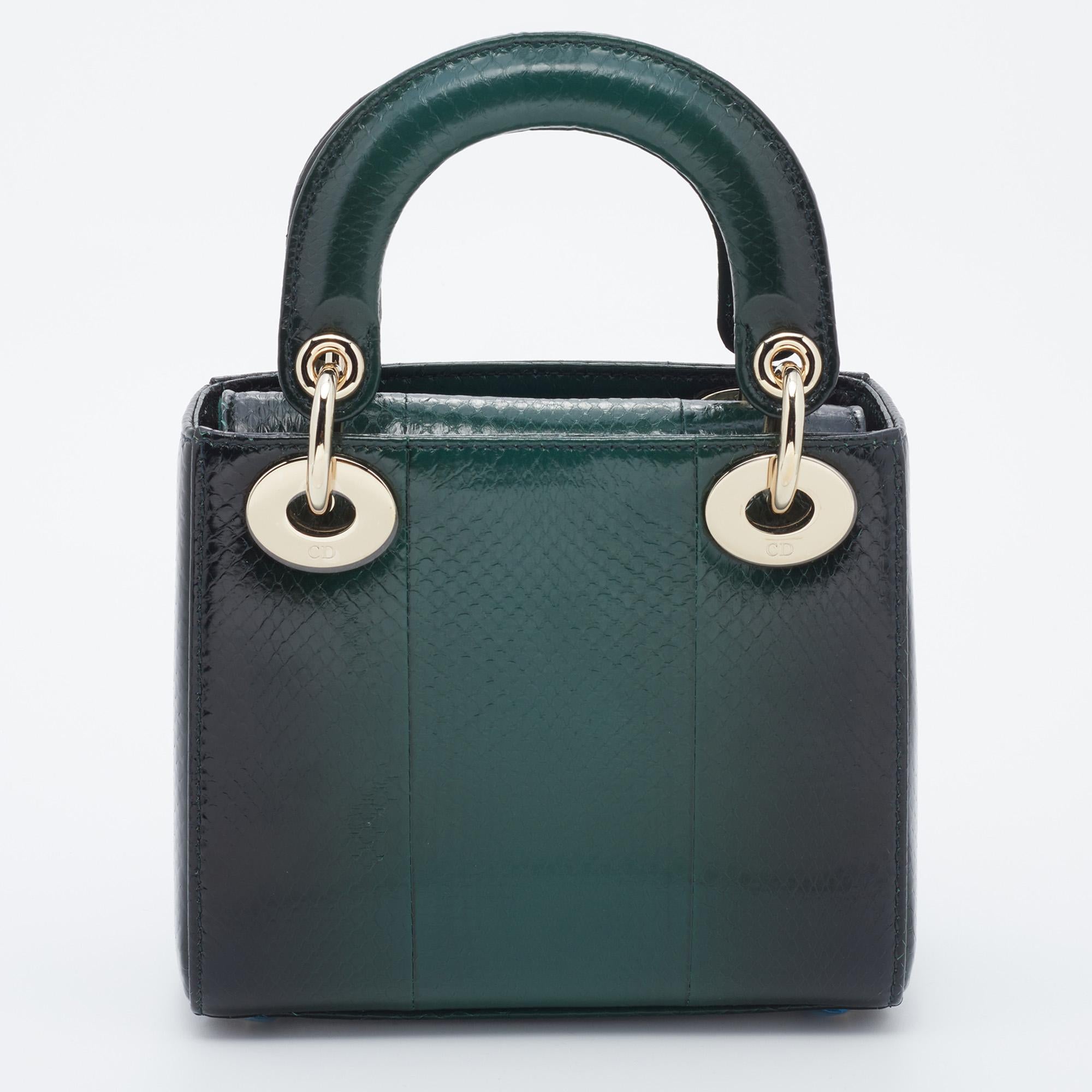 A timeless status and great design mark the Lady Dior tote. It is an iconic bag that people continue to invest in to this day. We have here this mini Lady Dior chain tote crafted from Ayers leather. The mesmerizing green bag is complete with two top