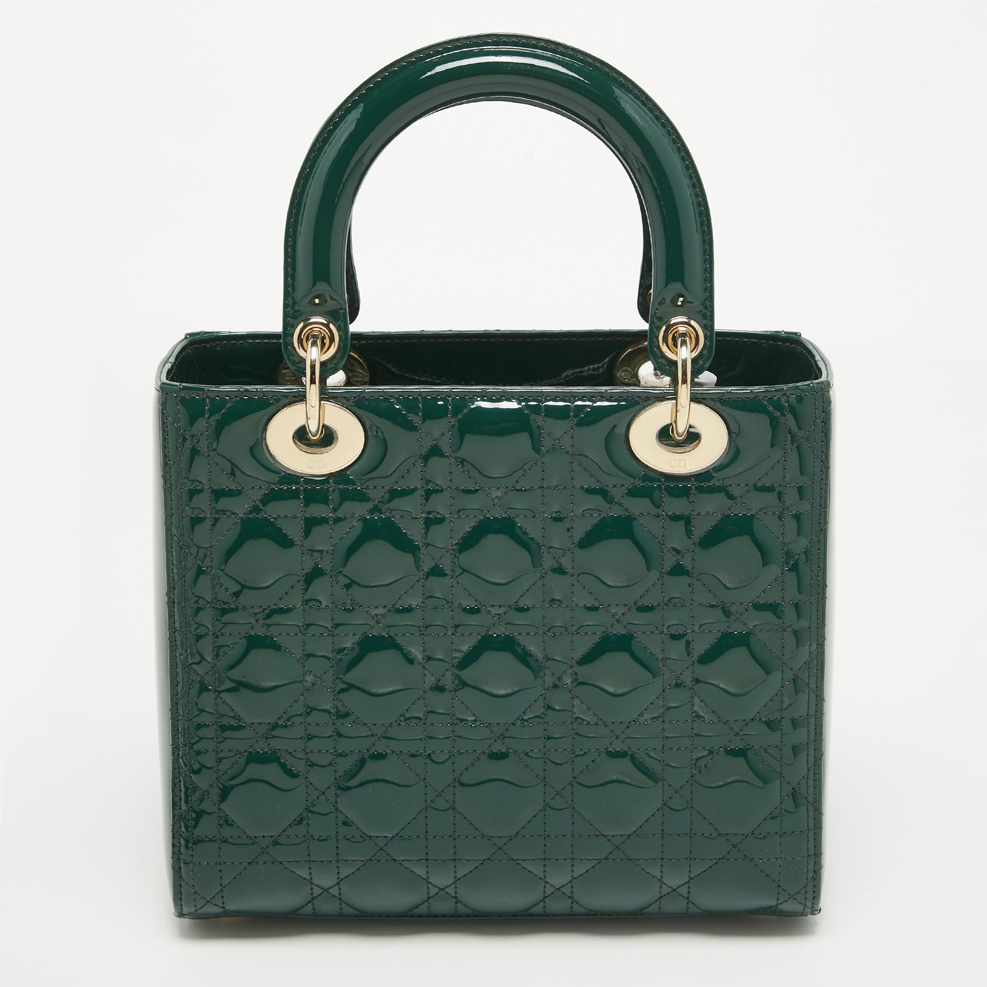 The Lady Dior tote is a Dior creation that has gained wide recognition and is a coveted bag that every fashionista craves to possess. The green tote has been crafted from patent leather and carries the signature Cannage quilt. It is equipped with a