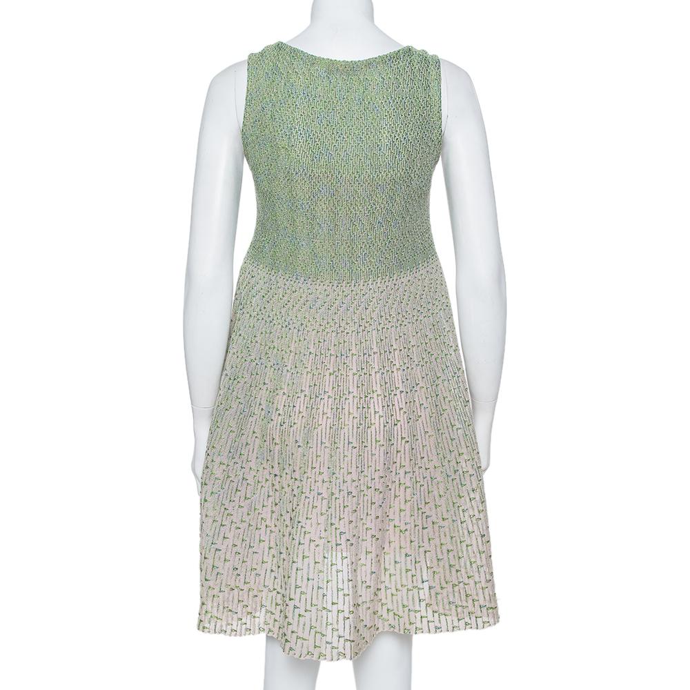 A chic appeal is what this tent dress from Dior exudes! The green and pink creation features a lurex knit design with a flared silhouette and comes with a scooped neckline and a slit detail. It will look great with pointed pumps and a sling bag.

