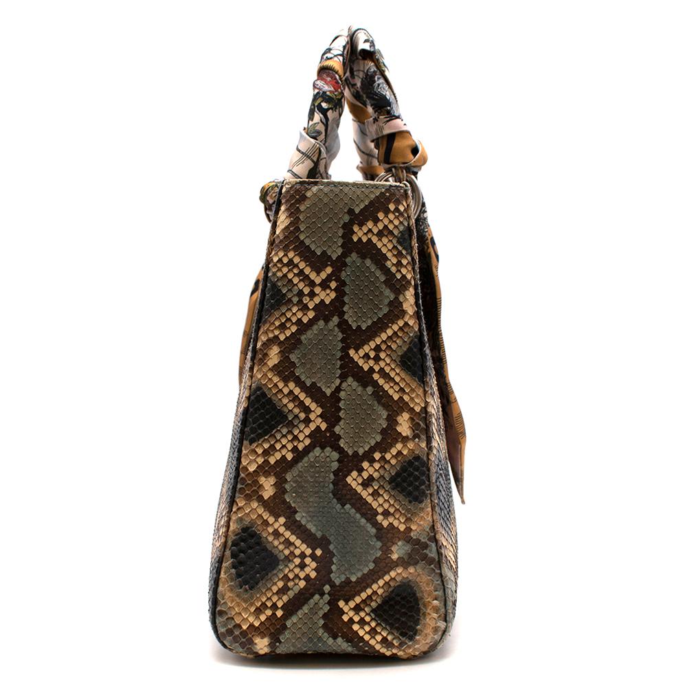 Dior Python Large Lady Dior Bag

-Gorgeous multicolour python exterior
-Silver tone hardware
-Classic Dior charm
-Brown leather interior
-Zip pocket inside
-Metal feet
-Classic, timeless design
- The handles are wrapped with two silk twilly's which