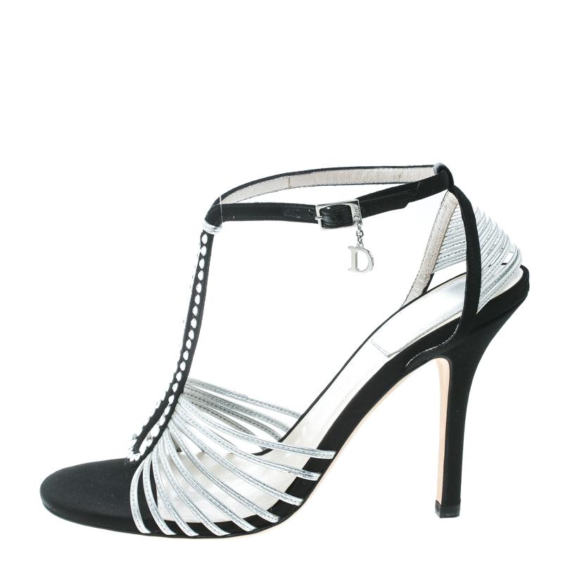These stunning sandals from Dior are sure to set hearts racing! The grey and black sandals have been crafted from leather and satin in an open toe silhouette and styled with crystal embellished cut-out detailed vamp straps. They flaunt buckled ankle