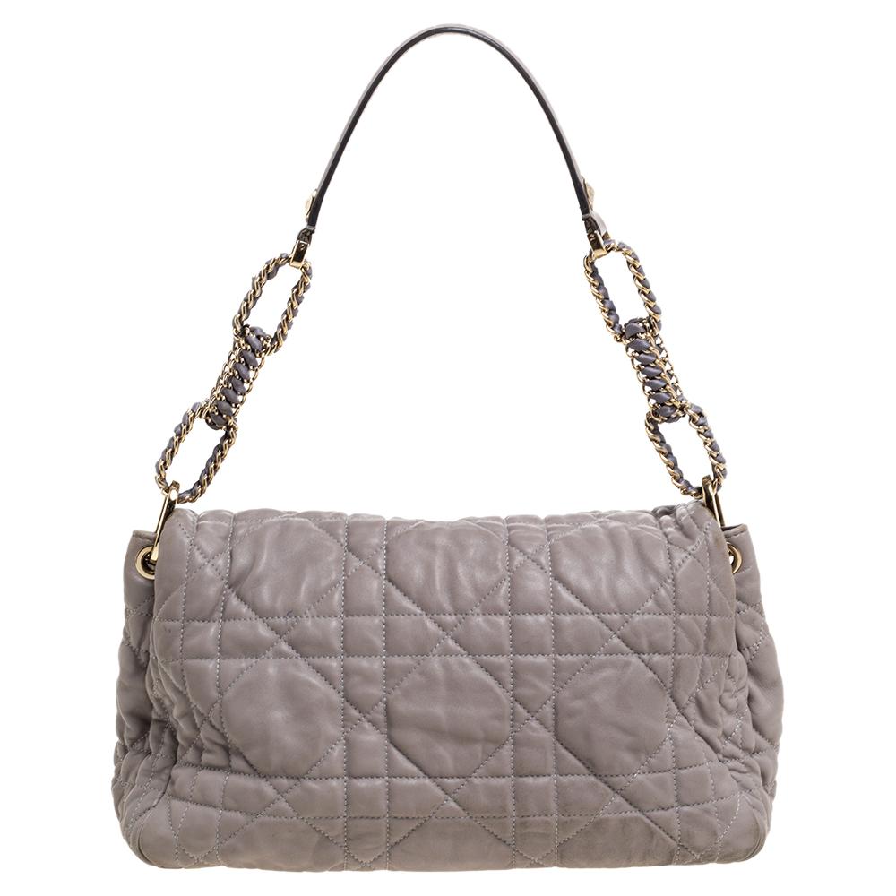 Fall in love almost instantly with this lovely bag from Dior. It is crafted from grey leather and features the brand's signature cannage pattern on the exterior. It has a front flap that opens to a spacious coated canvas interior and is held by a