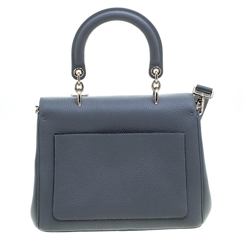 Flap bags as gorgeous as this one from Dior will never go out of style. This beauty has been meticulously crafted from leather and equipped with a single rolled top handle, a removable shoulder strap, protective metal feet at the bottom and the