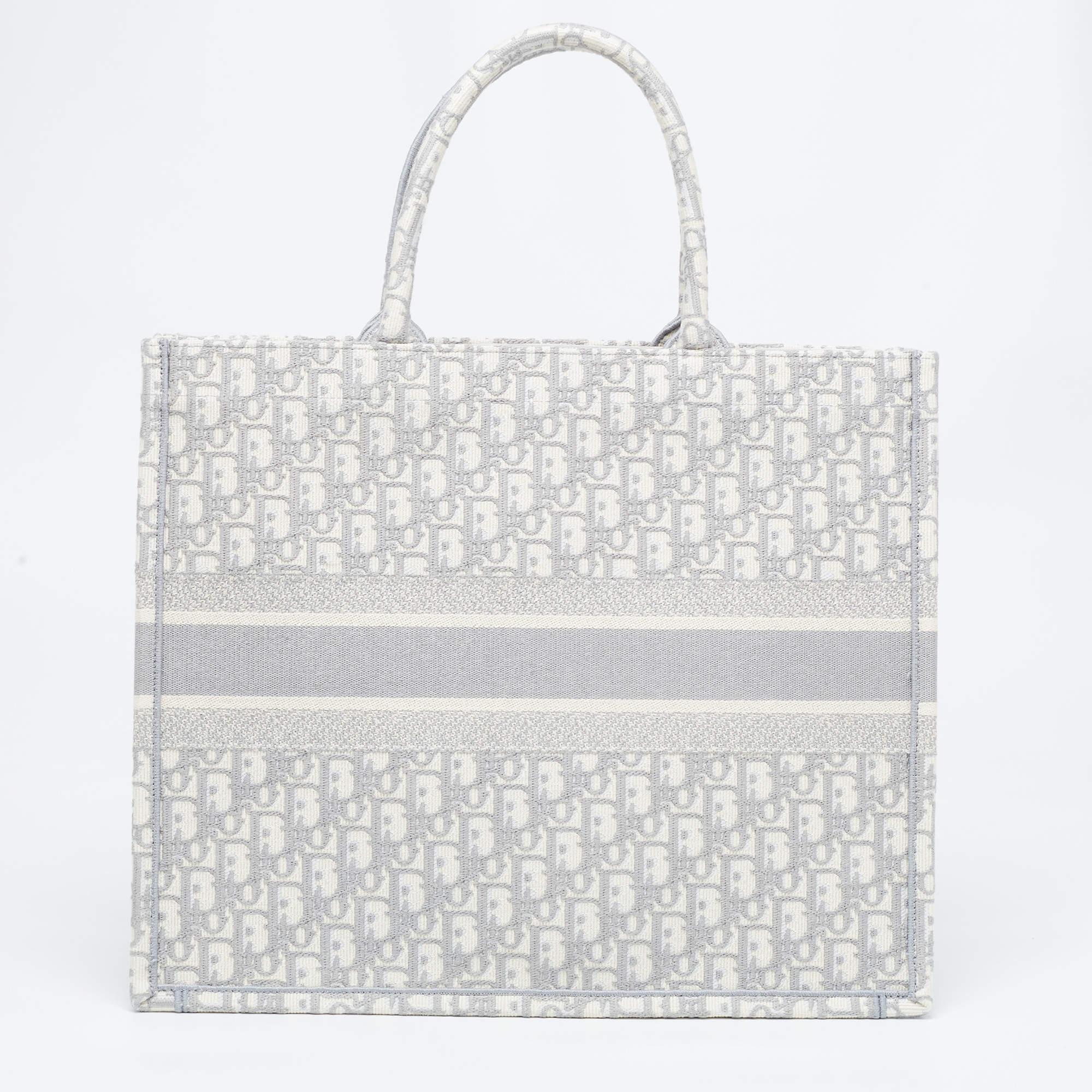 Designed by Maria Grazia Chiuri, the Dior Book Tote is a travel accessory for people with style. The bag here is crafted using canvas into a beautiful structure and covered in --- all over. Two handles, the 'Christian Dior' signature, and a spacious