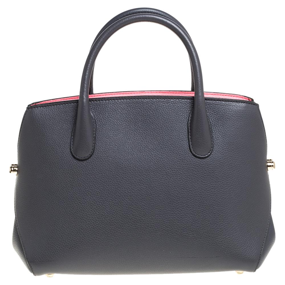 Expertly designed from leather, this tote exhibits an elegant design. Designed to be spacious enough to carry your everyday essentials, this bag is lined with leather. Designed to last, this pretty creation from Dior is complete with a dual top