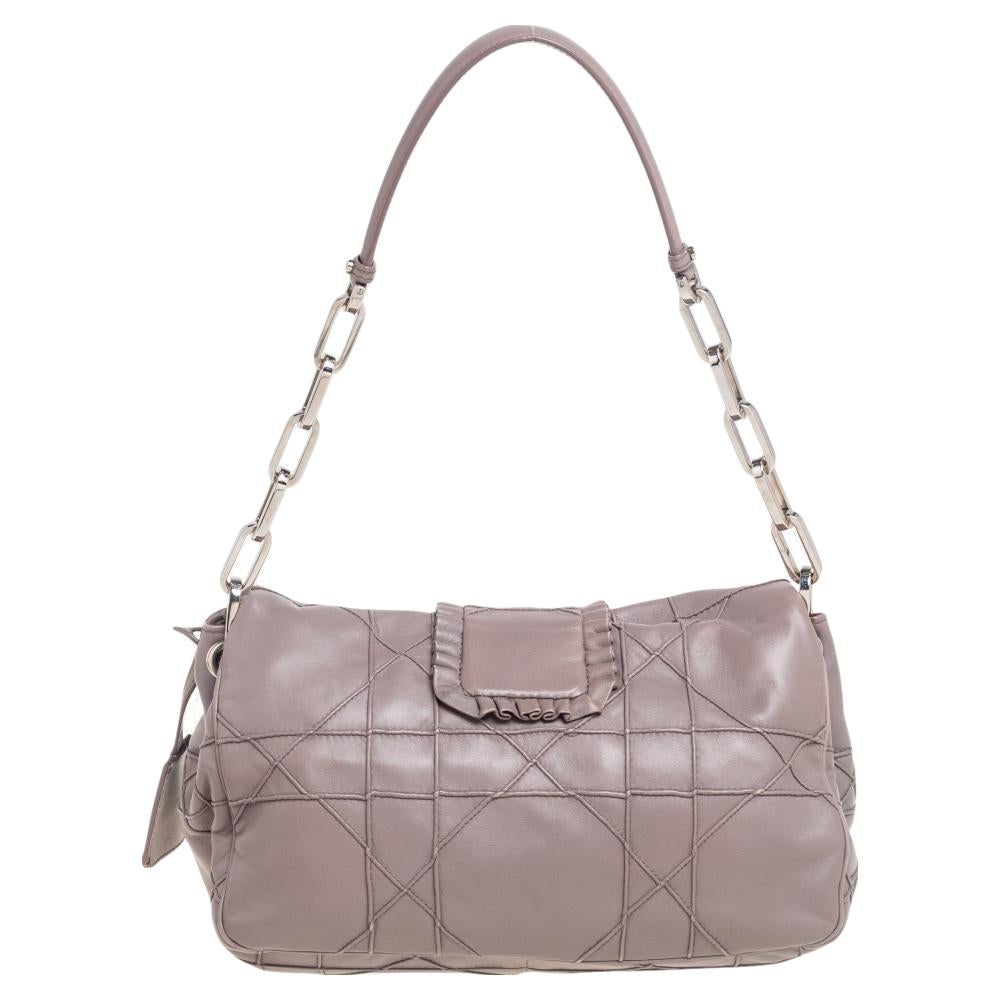 This Dior flap bag was named after 'New Look' which was actually coined by Christian Dior himself. Dazzling in a gorgeous grey shade, the bag is crafted from leather in their Cannage pattern and designed with a single handle and a front lock. The