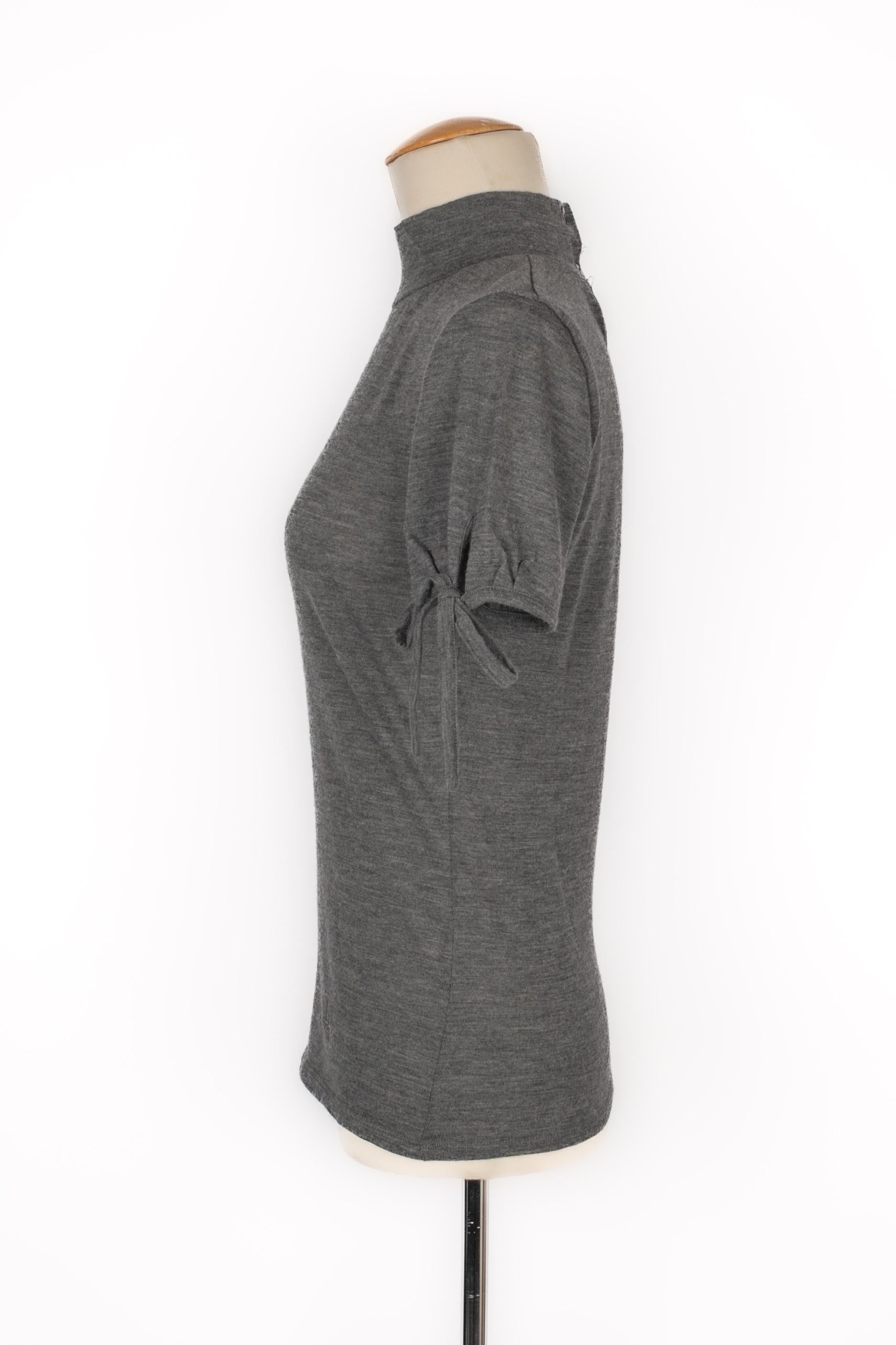 Dior - (Made in Italy) Grey woolen top. Size and composition labels missing, it fits a 38FR.

Additional information:
Condition: Very good condition
Dimensions: Shoulder width: 37 cm - Sleeve length: 18 cm - Length: 55 cm

Seller Reference: FH246