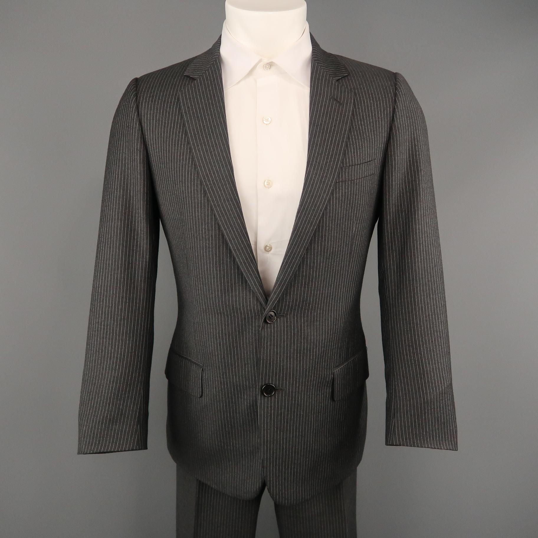 DIOR HOMME suit comes in gray pinstriped wool and includes a single breasted,  two button sport coat with notch lapel and matching flat  front trousers. Made in Italy.
 
Excellent Pre-Owned Condition.
Marked: IT 48 R
 
Measurements:

