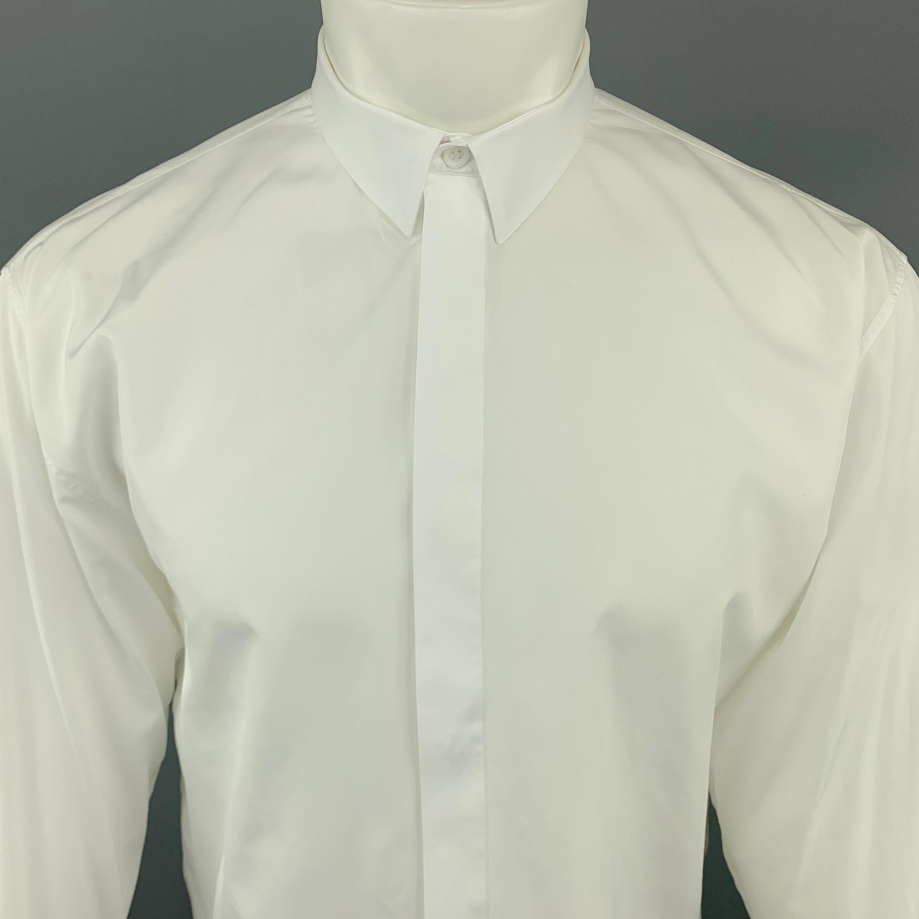 DIOR HOMME Long Sleeve Shirt comes in a white tone in a solid cotton material, with hidden buttons at closure, buttoned cuffs, button up, and a bee embroidered at front. Made in Italy.

Excellent Pre-Owned Condition.
Marked:
