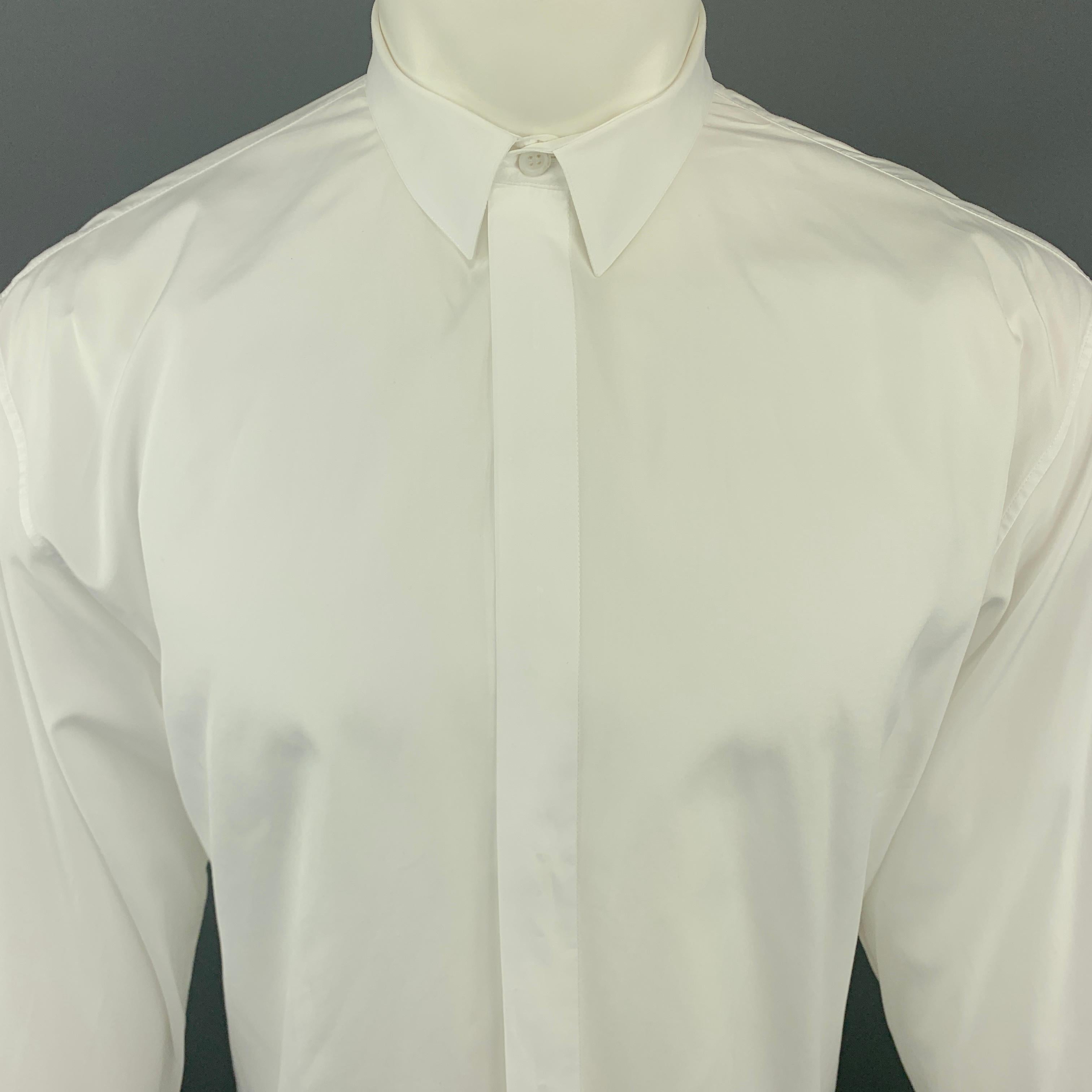 DIOR HOMME Long Sleeve Shirt comes in a white tone in a solid cotton material, with hidden buttons at closure, buttoned cuffs, button up, and a bee embroidered at front. Made in Italy.

Excellent Pre-Owned Condition.
Marked: