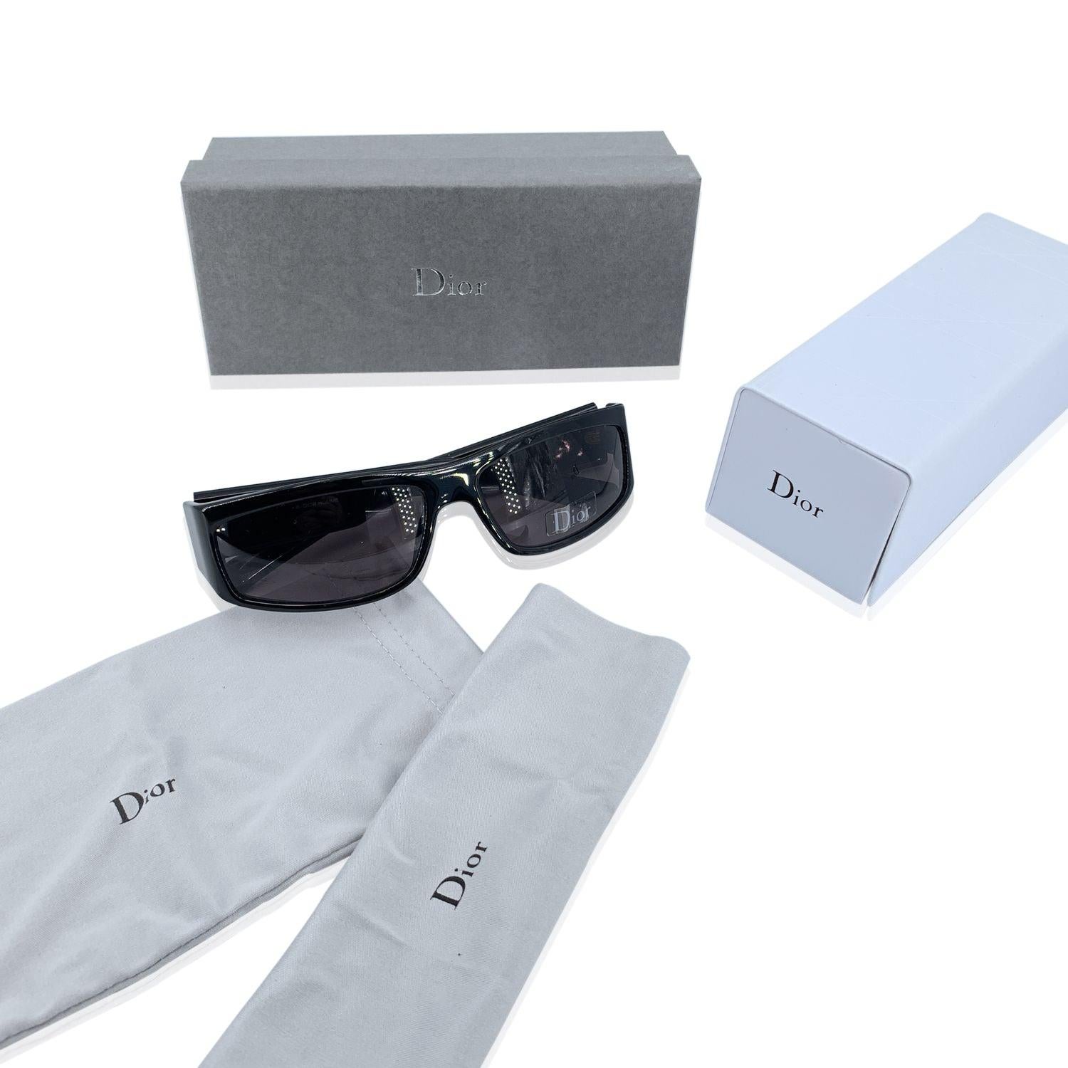 CHRISTIAN DIOR HOMME 'Black Tie' Sunglasses,mod. 5/S - 807 N. Size 59/15 125mm. Black acetate frame, sides with gold metal stripes on ear stems. 100% Total UVA/UVB protection grey lenses. Made in Italy. Details MATERIAL: Plastic COLOR: Black MODEL: