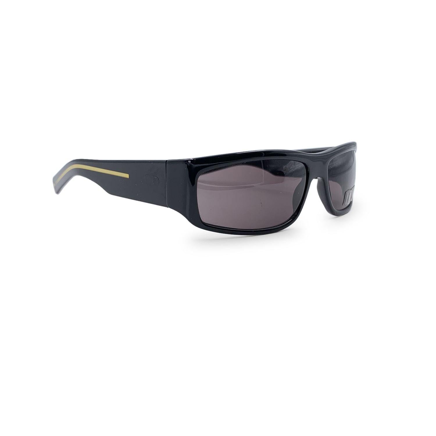 CHRISTIAN DIOR HOMME 'Black Tie' Sunglasses,mod. 5/S - 807 N. Size 59/15 125mm. Black acetate frame, sides with gold metal stripes on ear stems. 100% Total UVA/UVB protection grey lenses. Made in Italy. Condition A+ - MINT Never Worn, do defect or